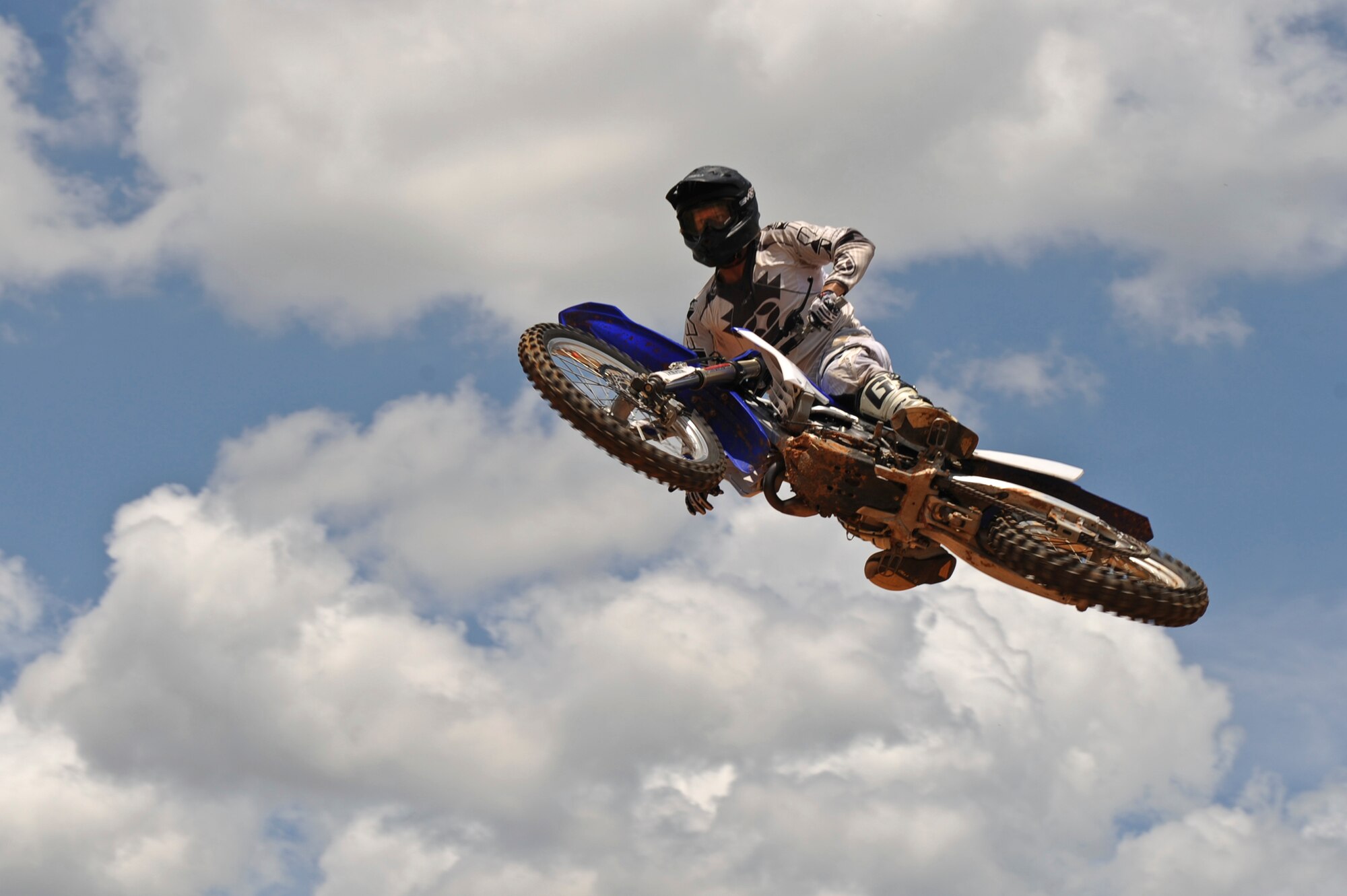 A local dirt bike enthusiast soars through the air over a dirt track in Mansfield, La., July 1. A few Barksdale Air Force Base Airmen enjoy riding and racing dirt bikes to unwind after a long work week. In order to ride and race dirt bikes, Airmen must complete the motorcycle safety course at Barksdale Air Force Base along with having a high-risk activity briefing from their commander. (U.S. Air Force photo/Airman 1st Class Micaiah Anthony)(RELEASED)
