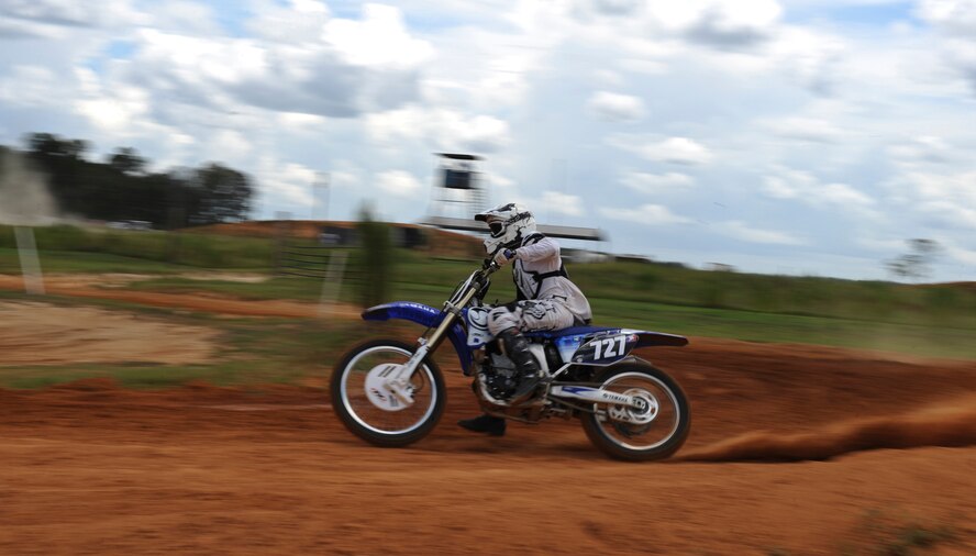 Tech. Sgt. Ryan Constantin, 2nd Logistics Readiness Squadron, goes in to a turn at a dirt track in Mansfield, La., July 1. In order to ride and race dirt bikes, Airmen must complete the motorcycle safety course at Barksdale Air Force Base along with having a high-risk activity briefing from their commander. (U.S. Air Force photo/Airman 1st Class Micaiah Anthony)(RELEASED)