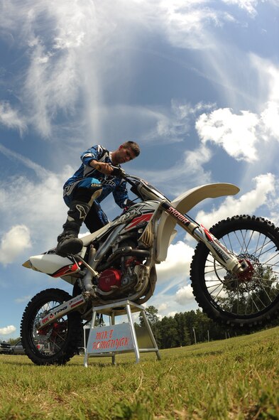 Airman 1st Class Michael Romanyak, 2nd Maintenance Squadron, starts his dirt bike at a track in Mansfield, La., July 1. Romanyak enjoys riding and racing dirt bikes on the weekend to unwind from a long week at work. (U.S. Air Force photo/Airman 1st Class Micaiah Anthony)(RELEASED)