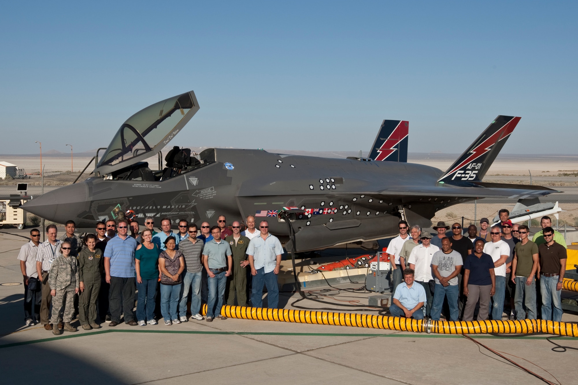 Group shot of the F-35 Combined Test Force team that performed stores static ejection testing on an F-35 for the past three weeks.  (U.S. Air Force photo by Paul Weatherman and David Henry/Lockheed Martin)
