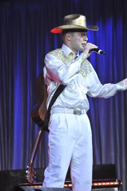 Airman 1st Class Timothy Sentz, 375th Communications Squadron client systems apprentice; Scott AFB, Ill.; talks to the audience about the value of country music before performing a solo.  The Tops In Blue troop performed different genres of music so that all types of music fans could enjoy the performance. (U.S. Air Force photo/John Turner)