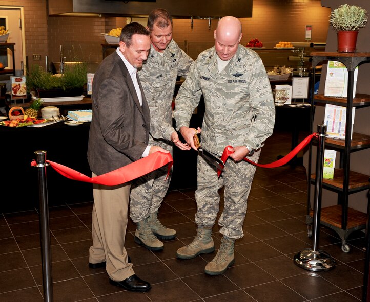 Brian Holzworth, Aramark general manager, Col. William Thomas, 336th Training Group commander, and Col. Paul Guemmer, 92nd Air Refueling Wing commander, cut the ribbon at the Roger A. Ross Dining Facility during its grand opening ceremony at Fairchild Air Force Base, Wash., June 27, 2012. The Ross is situated at the heart of the 336th TRG’s operations and is the primary means for providing the school’s students with the food they need to complete their rigorous training schedule. (U.S. Air Force photo/Senior Airman Benjamin Stratton) 

