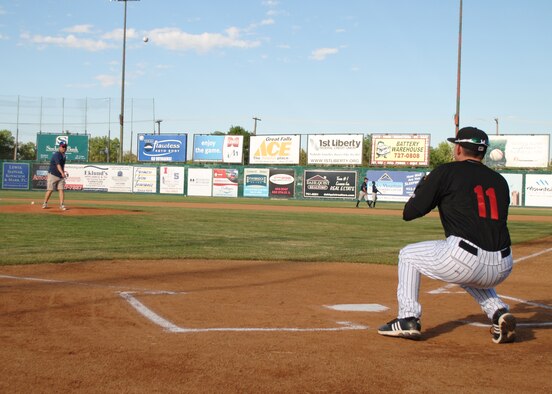Col. H.B. Brual, 341st Missile Wing commander, throws the first pitch to Zachary Voight, infielder for the Great Falls Voyagers, during Military Appreciation Night at Centene Stadium on June 30. Military members were given free tickets to the game at where the Voyagers beat the Helena Brewers by a score of 2-1. (U.S. Air Force photo/Airman 1st Class Katrina Heikkinen) 