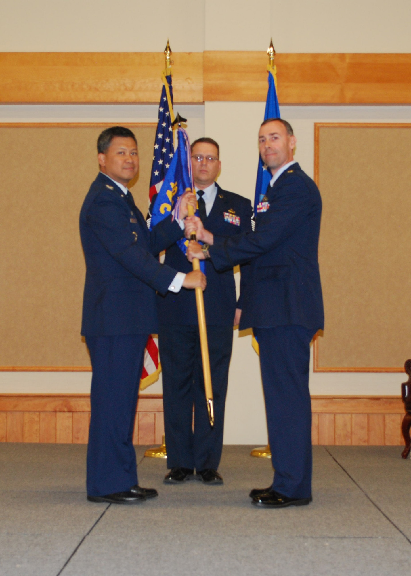 Maj. Chad McAdams, right, accepts command of the 341st Comptroller Squadron from Col. H.B. Brual, 341st Missile Wing commander, June 29 at the Grizzly Bend. Master Sgt. Rodney Martin, 341st CPTS financial services NCO in charge, looks on. (U.S. Air Force photo/Airman 1st Class Alison Shildt)