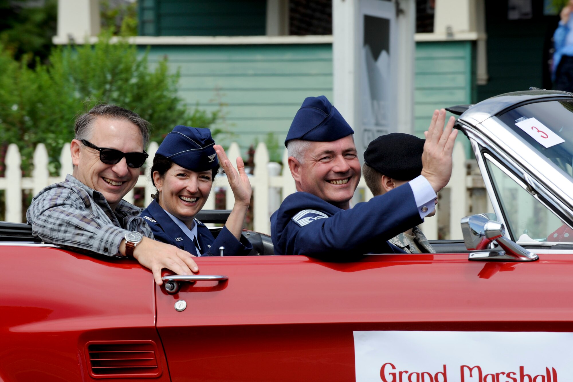 VANDENBERG AIR FORCE BASE, Calif. -- Col. Nina Armagno, center, 30th Space Wing commander, her husband Eddie Papczun, left, and Chief Master Sgt. Patrick Abbott, 30th Mission Support Group superintendent, wave to watchers of  the Celebrate Heroes Parade in Guadalupe Saturday, June 30, 2012. The parade was a recognition of active and veteran members of the military and the city of Guadalupe intends to continue that recognition annually. (U.S. Air Force photo/Staff Sgt. Levi Riendeau)
