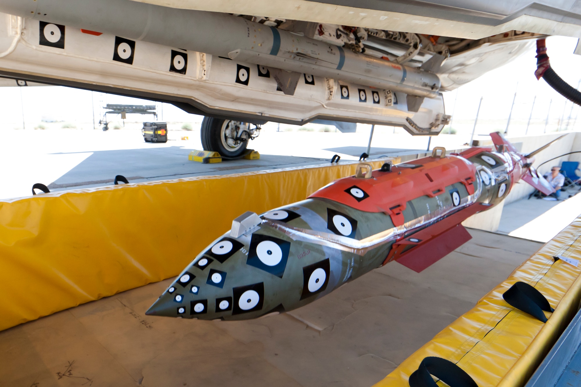 AF-1 drops a 2,000-lbs JDAM for stores static ejection testing.  The dot stickers on the aircraft and weapon are part of a complex camera system that accurately measures and models the aircraft’s motion. A series of high speed cameras surround the F-35 and photograph each store release. (U.S. Air Force photo by Paul Weatherman/Lockheed Martin)