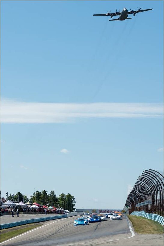 WATKINS GLEN, N.Y. - A C-130 Hercules aircraft from the 914th Airlift Wing, Niagara Falls Air Reserve Station, N.Y. flies above and with the GRAND-AM Road Racing, Rolex Series Daytona Prototypes as they start the Sahlen's Six Hours of The Glen race July 1, 2012 at Watkins Glen International.  (Courtesy photo)