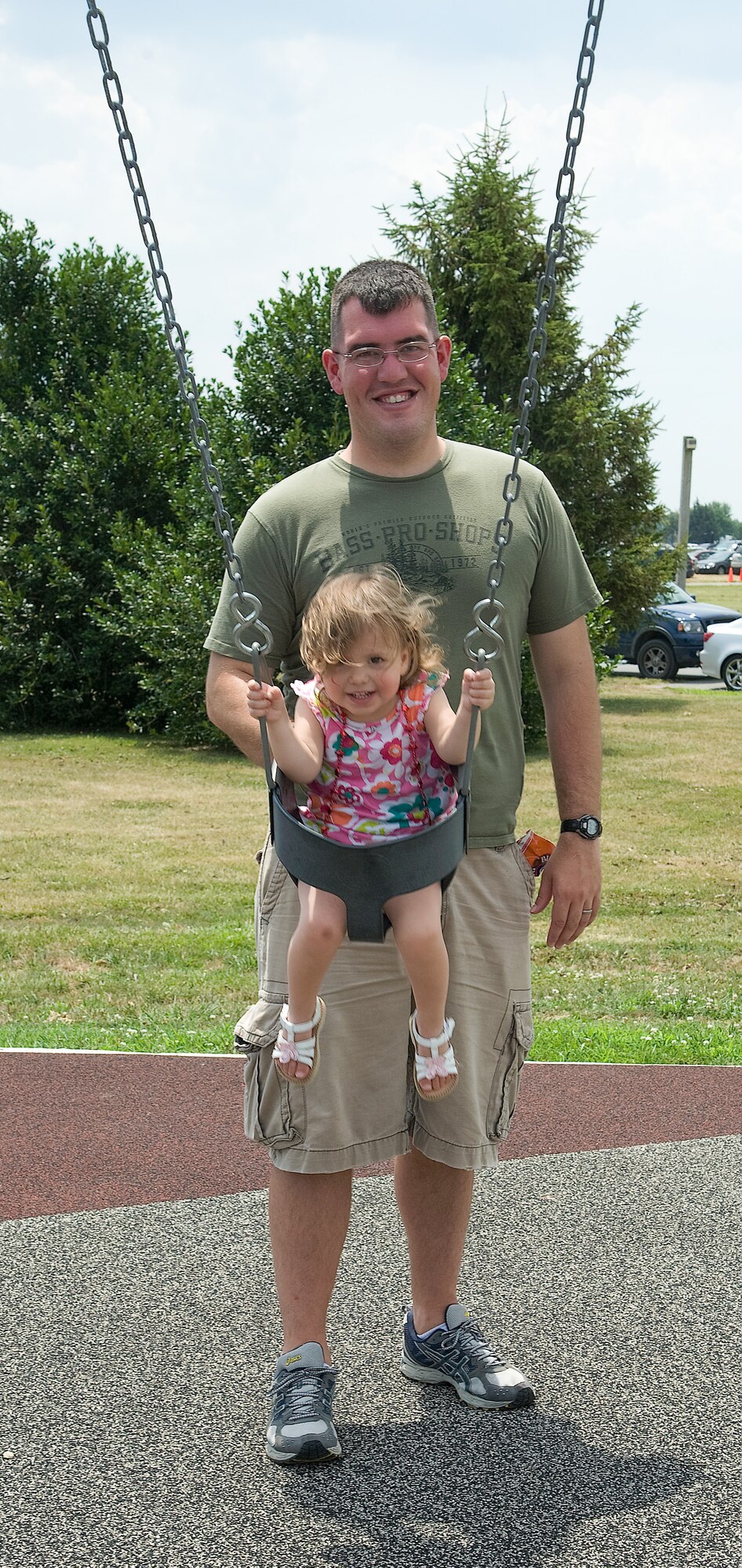 Staff Sgt. Chris Young pushes his daughter Elaina on a swing at the Wing Picnic July 3, 2012, at Dover Air Force Base, Del. Young took a break from the Wing Picnic activities to give his daughter a ride on the swing. (U.S. Air Force photo by Adrian Rowan)
