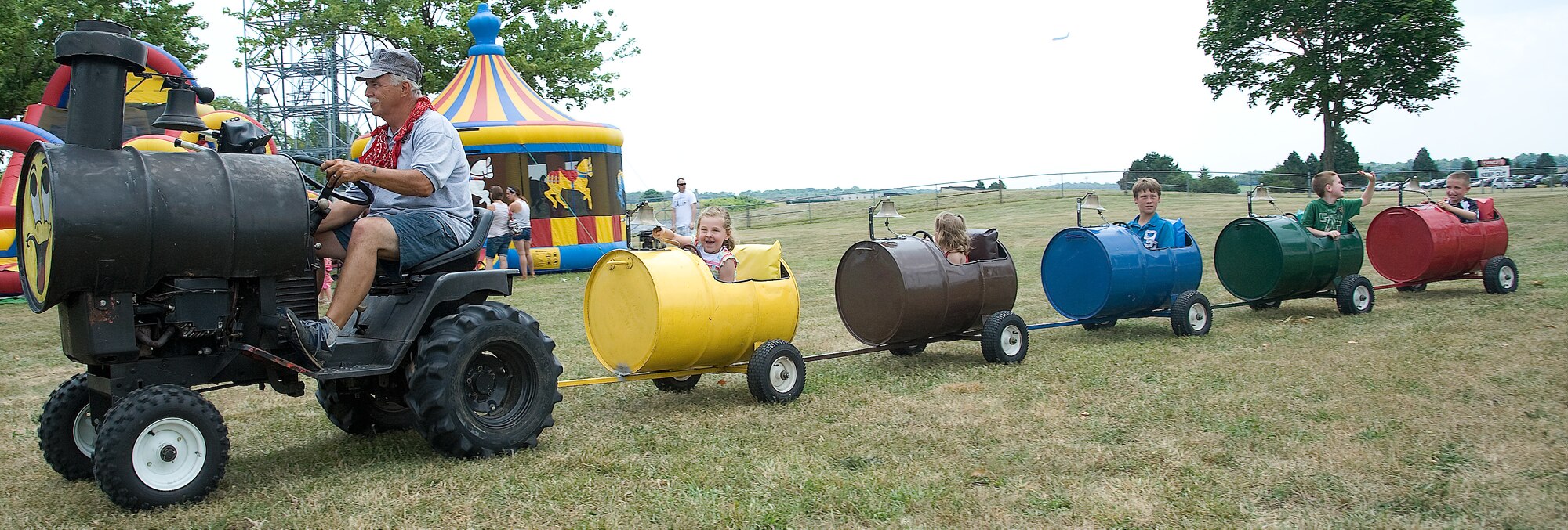 Kids take a ride on the train at the Wing Picnic July 3, 2012, at Dover Air Force Base, Del. The train was one of many rides children could enjoy at the base-wide event. (U.S. Air Force photo by Adrian Rowan)