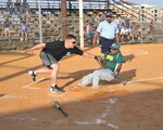 433rd Airlift Wing outfielder Ralph Ozuna slides into home plate as 453rd Electronic Warfare Squadron catcher Mike Hinger tags him in the first inning during Division III Recreational League play. Ozuna was ruled out at the plate. (U.S. Air Force photo/Alan Boedeker)