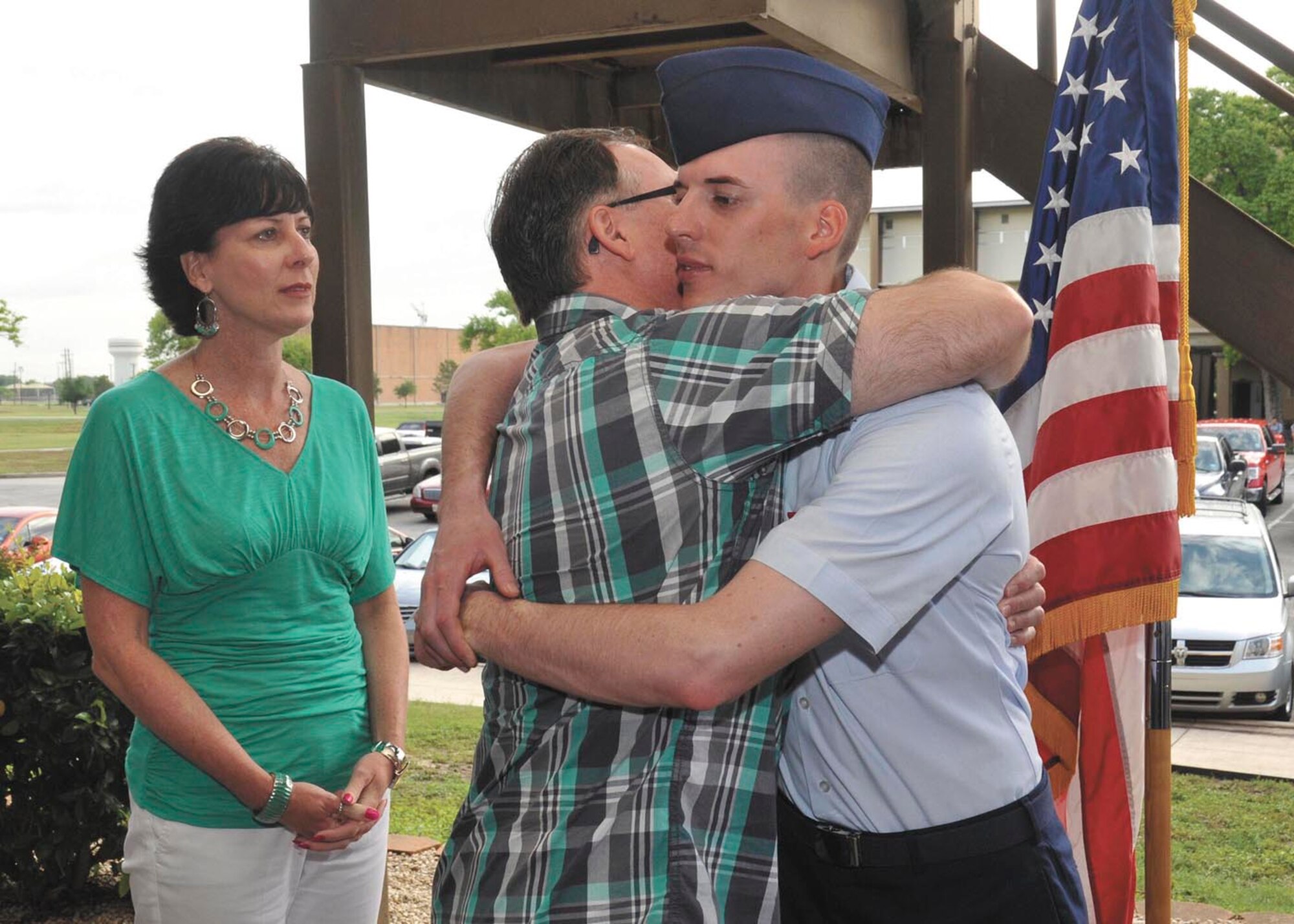Airman Luke Bolen hugs his father, Brian Bolen, as mother Lisa looks on during the Air Force Basic Military Training graduation ceremony May 11 at the 321st Training Squadron. Bolen was diagnosed with Guillain-Barre Syndrome while at basic training. He recovered to complete basic training, graduating six months after his arrival. (U.S. Air Force photo/Alan Boedeker)