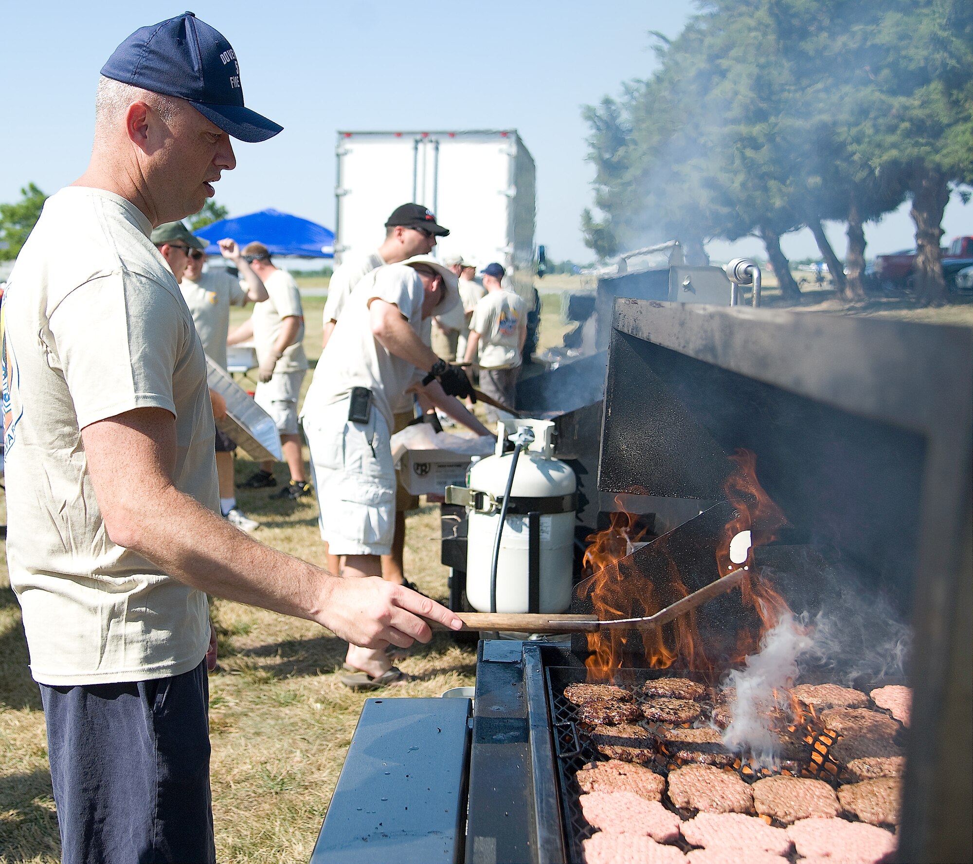 Master Sgt. Patrick Galvin cooks on the grill during the Wing Picnic July 3, 2012, at Dover Air Force Base, Del. The base-wide event featured food, fun and games for all DoD card holders and their families. (U.S. Air Force photo by Adrian Rowan)