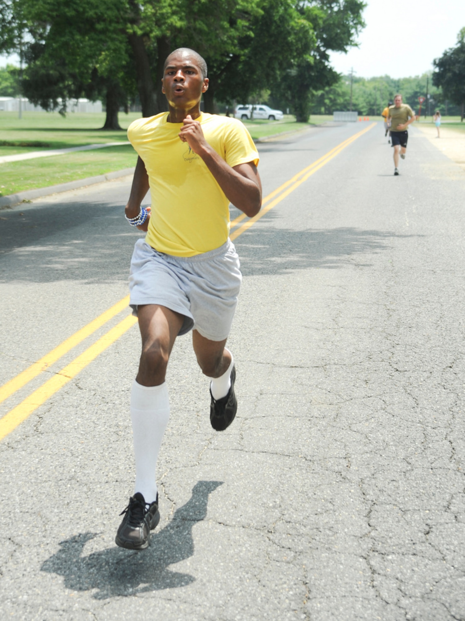 John Adams, 16, a native of Los Angeles, sprints to the finish line during the 87th Force Support Squadron's Firecracker 5K held at Doughboy Field on Joint Base McGuire-Dix-Lakehurst June 28. Adams is a member of theNew Jersey Youth Challenge Academy and was one of 25 who both assisted and participated in the event. (U.S. Air Force by 2nd Lt. David Murphy/Released)