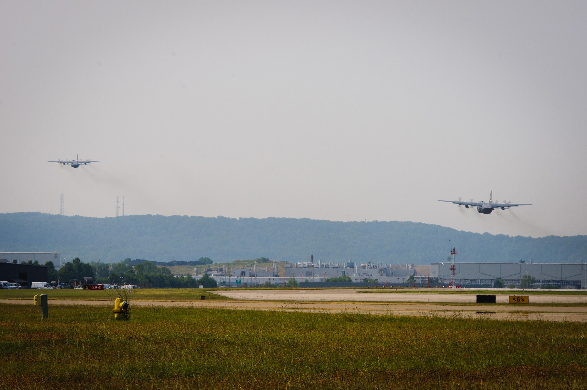 Two Kentucky Air Guard C-130 aircraft take off from the Kentucky Air National Guard Base in Louisville, Ky., on July 2, 2012, for a four-month deployment to the Persian Gulf. The 123rd Airlift Wing is sending 70 Airmen in support of operations Enduring Freedom and New Dawn. (U.S. Air Force photo by Master Sgt. Phil Speck)