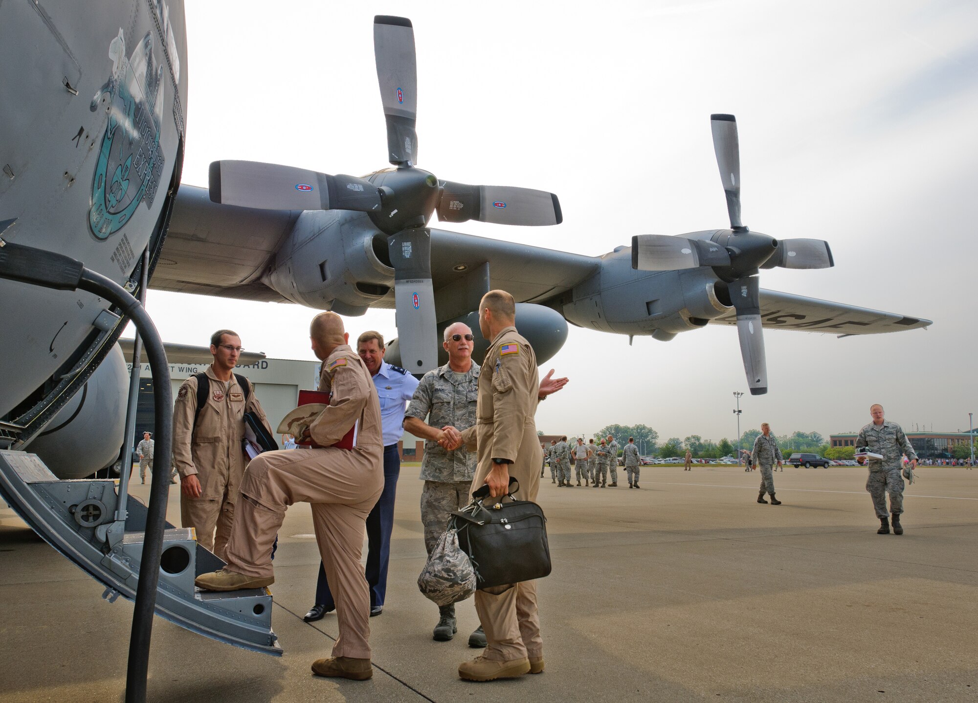 Kentucky's adjutant general, Maj. Gen. Edward W. Tonini, and Brig. Gen. Mark Kraus, Kentucky's assistant adjutant general for Air, shake hands with Airmen from the 123rd Airlift Wing as they board a C-130 at the Kentucky Air National Guard Base in Louisville, Ky., prior to a deployment to the Persian Gulf region on July 2, 2012. The wing deployed 70 Airmen and two C-130 aircraft in support of operations Enduring Freedom and New Dawn. (U.S. Air Force photo by Master Sgt. Phil Speck)