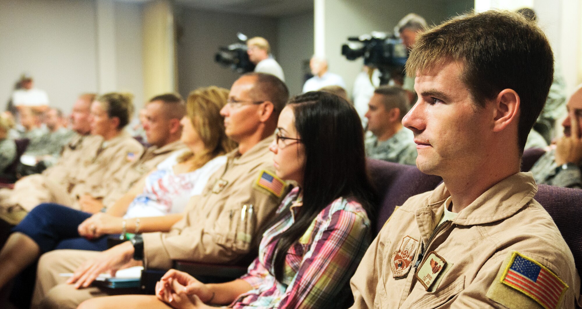 Tech. Sgt. Benjamin Vost, a flight engineer for the 165th Airlift Squadron, listens to a pre-deployment briefing prior to takeoff at the Kentucky Air National Guard Base in Louisville, Ky., on July 2, 2012. The 123rd Airlift Wing deployed 70 Airmen and two C-130 aircraft to the Persian Gulf region in support of operations Enduring Freedom and New Dawn. The mission marks the wing's seventh major deployment to the U.S. Central Command Area of Responsibility since 2003. Previous missions sent hundreds of Kentucky Air Guard forces to multiple locations in Afghanistan, Iraq and Saudi Arabia.(U.S. Air Force photo by Master Sgt. Phil Speck)