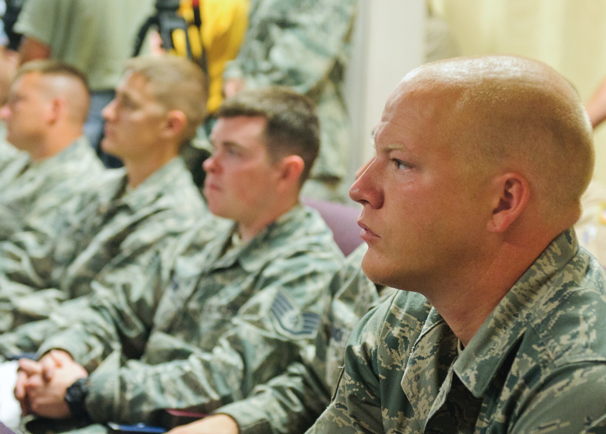 Tech. Sgt. Matthew Hourigan, an aircraft mechanic for the Kentucky Air National Guard's 123rd Aircraft Maintenance Squadron, listens to a pre-deployment briefing prior to takeoff at the Kentucky Air National Guard Base in Louisville, Ky., on July 2, 2012. The 123rd Airlift Wing deployed 70 Airmen and two C-130 aircraft to the Persian Gulf region in support of operations Enduring Freedom and New Dawn. (U.S. Air Force photo by Master Sgt. Phil Speck)