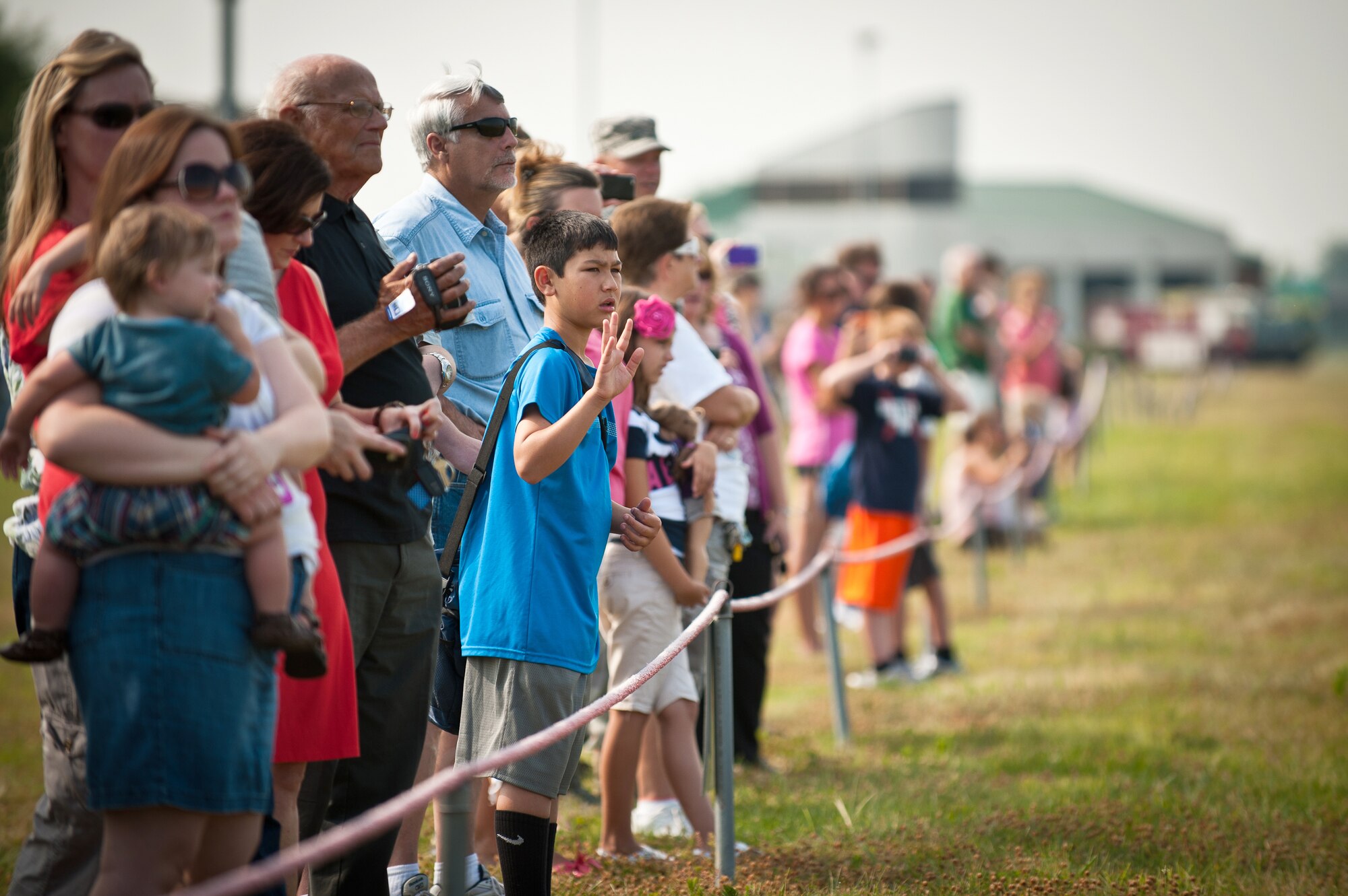 Family members wave goodbye their loved ones at the Kentucky Air National Guard Base in Louisville, Ky., on July 2, 2012, as the unit deploys 70 Airmen and two C-130 Aircraft to the Persian Gulf for a four-month tour in support of operations Endurting Freedom and New Dawn. The Kentucky Airmen will fly troops and cargo across the U.S. Central Command Area of Responsibility as part of the 386th Air Expeditionary Wing. (U.S. Air Force photo by Maj. Dale Greer)