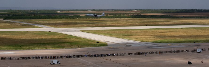 Dyess personnel line the flightline to salute as the first of sixteen C-130Js that took off for a training exercise July, 2, 2012, at Dyess Air Force Base, Texas. The simulated mission was an airdrop above two different drop zones. Once the final aircraft was airborne, the 317th Airlift Group made history, flying the largest C-130J formation ever. The first C-130J was delivered April 16, 2010, by Air Force Chief of Staff Gen. Norton Schwartz. Dyess has since received 20 more and is scheduled to get a total of 28 Js, making it the largest C-130J unit in the world. (U.S. Air Force photo by Airman 1st Class Damon Kasberg/Released)