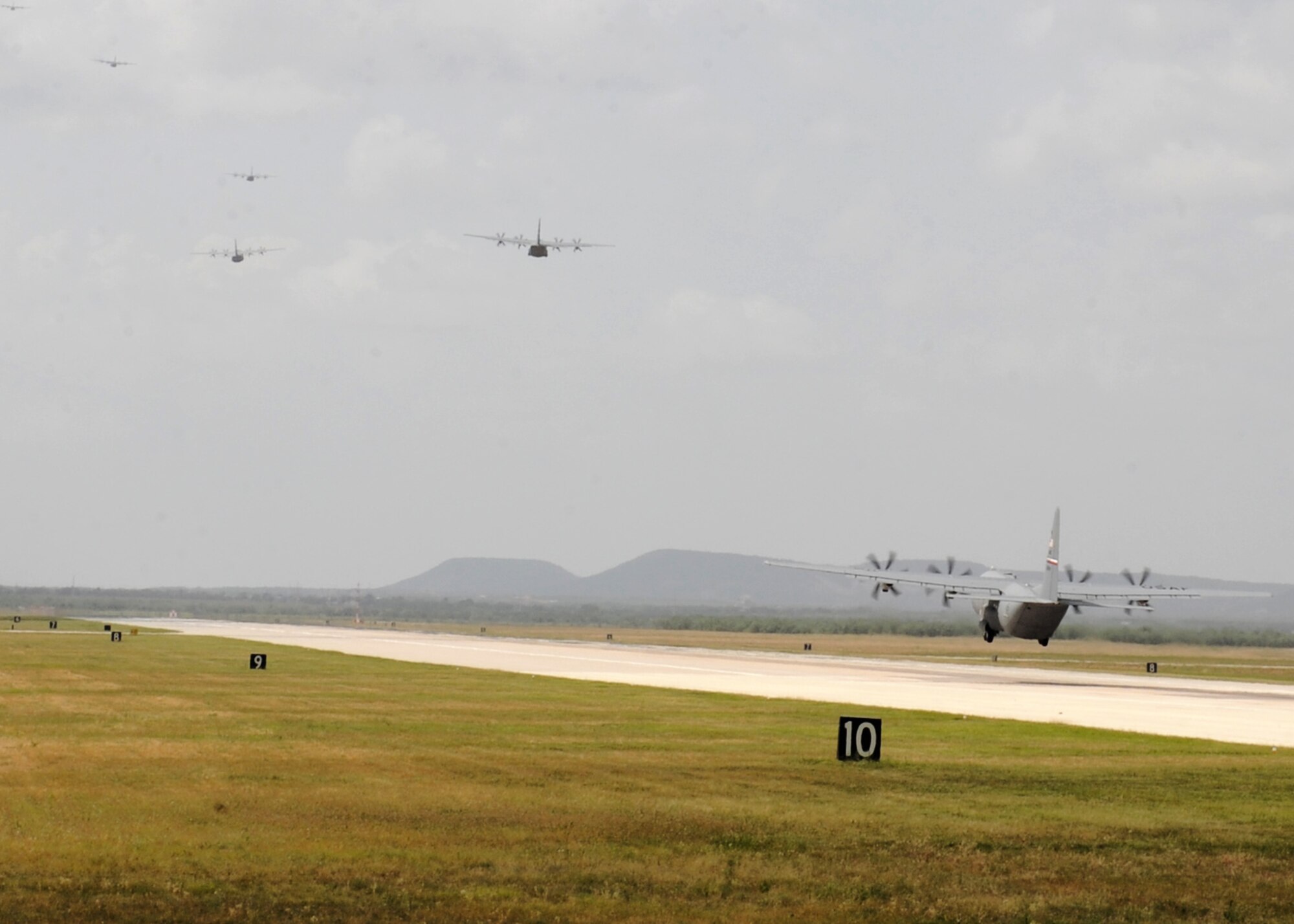 A 317th Airlift Group C-130J Super Hercules takes off for a training exercise July 2, 2012, at Dyess Air Force Base, Texas. The simulated mission was an airdrop above two different drop zones. Once the final aircraft was airborne, the 317th AG made history, flying the largest C-130J formation ever. The first C-130J was delivered April 16, 2010, by Air Force Chief of Staff Gen. Norton Schwartz. Dyess has since received 20 more and is scheduled to get a total of 28 Js, making it the largest C-130J unit in the world. (U.S. Air Force photo by Airman 1st Class Peter Thompson/ Released)