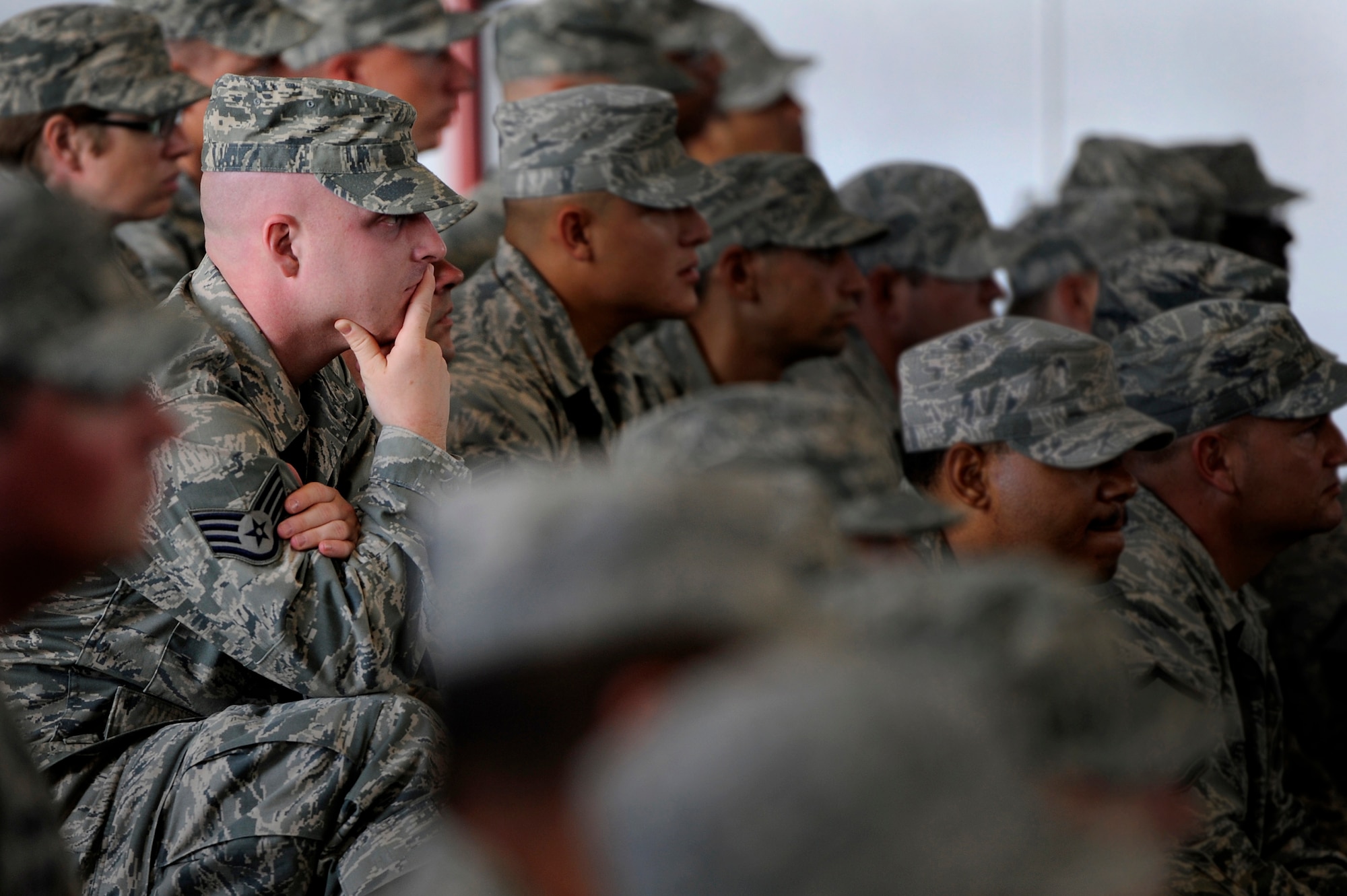 A U.S. Air Force staff sergeant assigned to the 20th Equipment Maintenance Squadron at Shaw Air Force Base, S.C., listens intently to his new squadron commander, Maj. Joshua Wennrich as he addresses the unit for the first time during a change of command ceremony, June 29, 2012. Lt. Col. James Smith, outgoing 20th EMS commander relinquished command to Wennrich during the ceremony. Wennrich arrived at Shaw from Royal Air Force Lakenheath Air Base, England. (U.S. Air Force photo by Senior Airman Kenny Holston/Released)