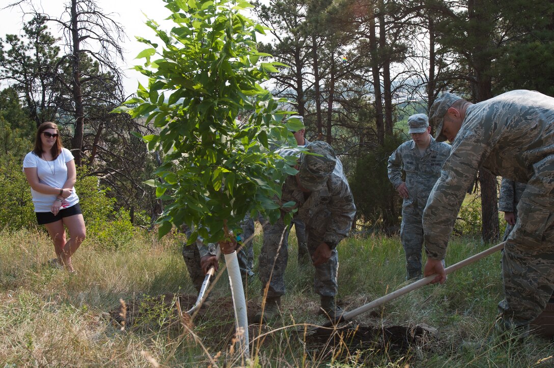 Erin Berky, wife of Staff Sgt. Bryan Berky, an explosive ordnance disposal technician from the 28th Civil Engineer Squadron, who was killed in action in 2009, reflects on her husband’s life as his friends and fellow Airmen plant a hackberry tree in his honor on M Hill at Hanson Larsen Memorial Park in Rapid City S.D., June 29, 2012. Berky chose this site to commemorate the adventurous life of her husband, after he died from wounds he sustained while under enemy fire during a combat operation near Bala Baluk, Afghanistan Sept. 12, 2009. (U.S. Air Force photo by Airman 1st Class Zachary Hada/Released)