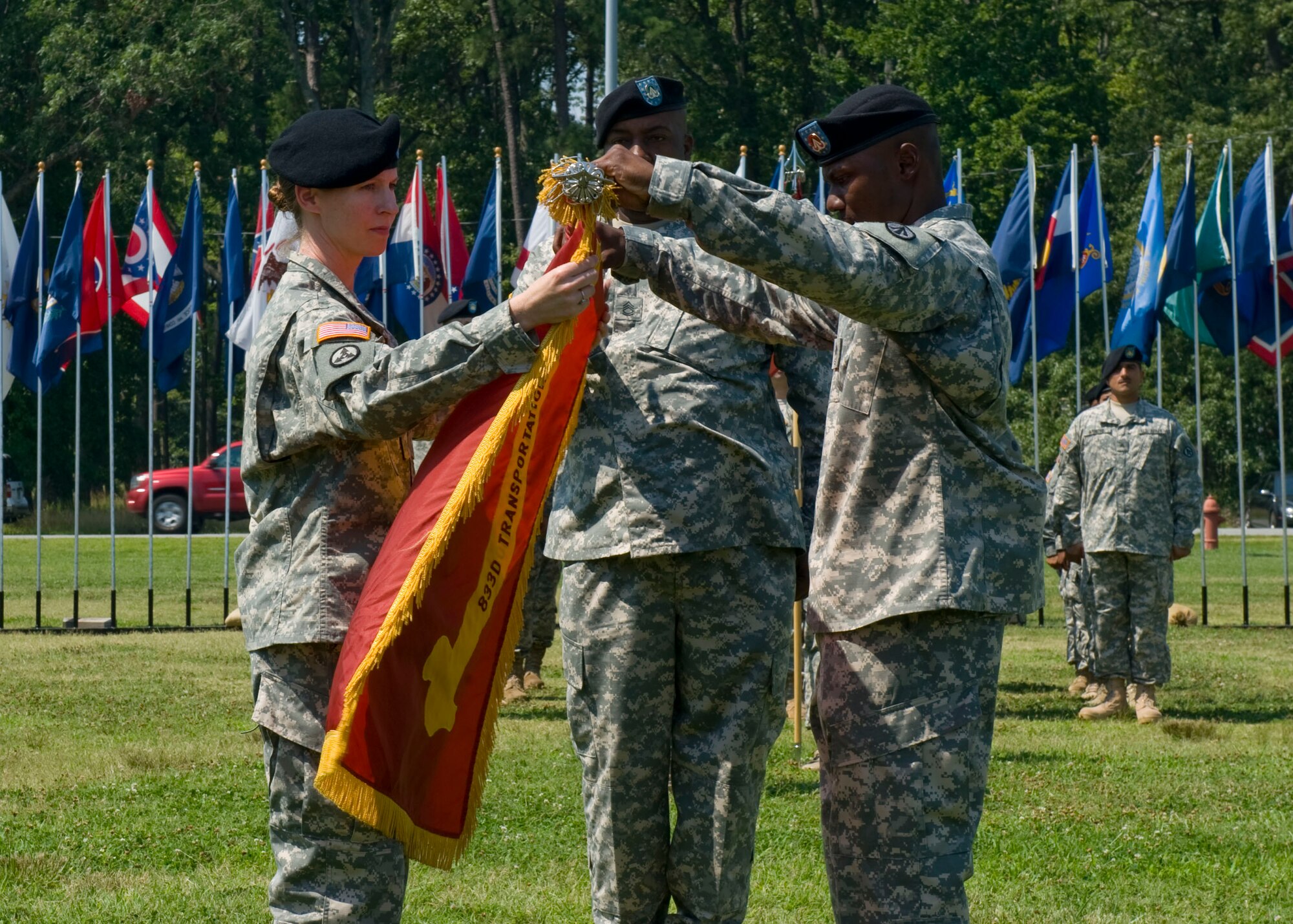 (From left) U.S. Army Lt. Col. Isabel Geiger, the 833rd Transportation Battalion commander, and Master Sgt. Cedric Richardson, also from the 833rd Trans. Bde., unfurl the unit colors during an uncasing ceremony at Ft. Eustis, Va., July 2, 2012. Effective June 28, the 833rd Trans. Bde. relocated to Ft. Eustis from Seattle, Wash., aligning the 688th, 689th and 690th  Rapid Port Opening Elements under one command while maintaining the Pacific Northwest Detachment in Seattle. (U.S. Air Force photo by Senior Airman John D. Strong II/Released)
