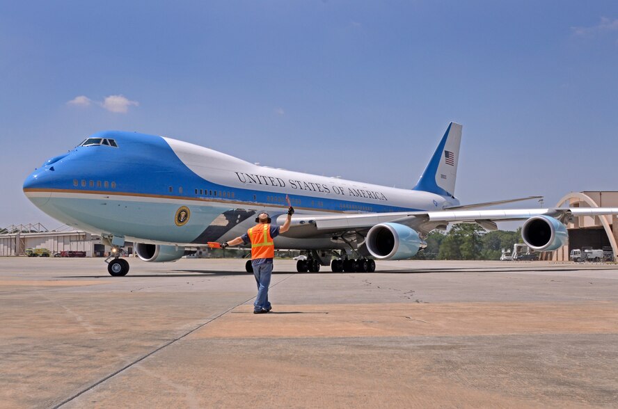 Transient Alert Aircraft Servicer, Charles Eberhart, marshals an Air Force VC-25 out of the parking area for departure from Dobbins ARB, Jun 26. The aircraft made a stopover at Dobbins as backup to the other VC-25 or Air Force One, which was carrying the president on a trip to Atlanta, Ga. and Miami, Fla.  (U.S. Air Force photo/ Brad Fallin)