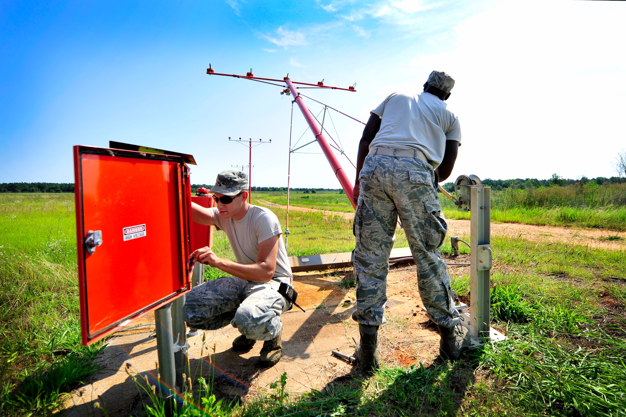 U.S. Air Force Airman 1st Class Justin Fleming, (left), and Staff Sgt. Julius Givens, 20th Civil Engineer Squadron, make repairs to airfield approach lighting, Shaw Air Force Base, S.C., June 26, 2012. Shaw’s airfield lighting system is vital to all pilots who land and take off from the flightline. (U.S. Air Force photo by Senior Airman Kenny Holston/Released)