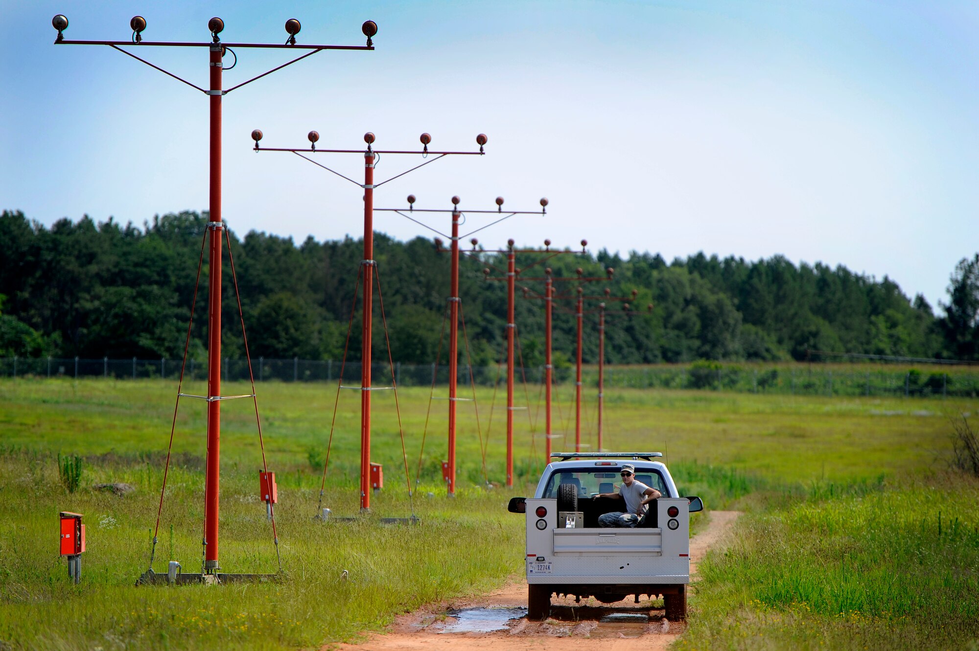 U.S. Air Force Airmen assigned to the 20th Engineer Squadron drive out to Shaw’s airfield approach lighting systems to complete repairs on some of the lights, Shaw Air Force Base, S.C., June 26, 2012. Tech. Sgt. Daniel Harrington, 20th CES, led a team of Airmen to repair several airfield lighting lamps and re-sync flashing approach lights. Shaw’s airfield lighting system is vital to all pilots who land and take off from the flightline. (U.S. Air Force photo by Senior Airman Kenny Holston/Released)