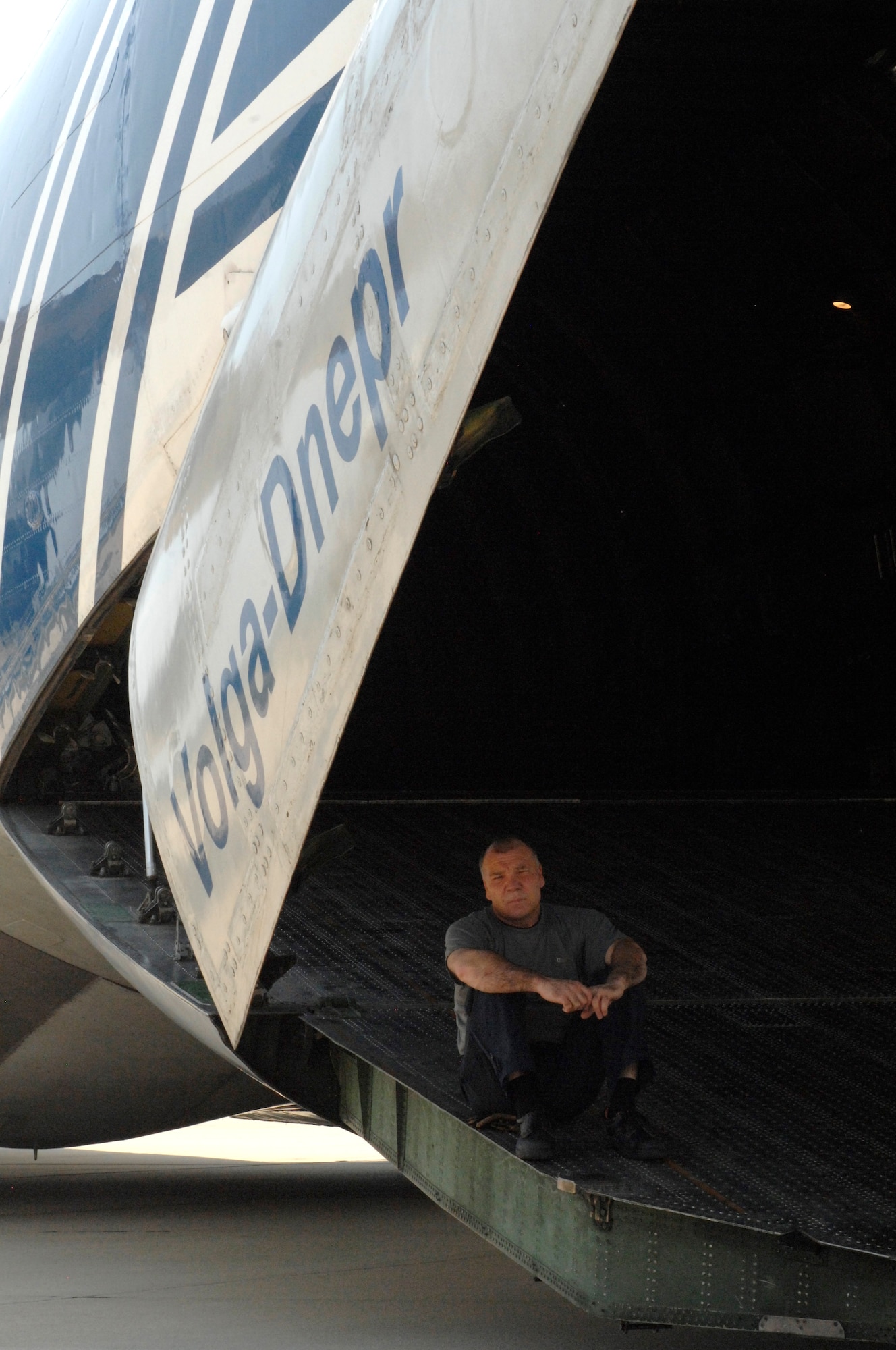 Alexander Maleev, a Russian crewmember, waits as the 20th Logistics Readiness Squadron prepares to load cargo onto a Russian Antonov An-124 Ruslan at Shaw Air Force Base, S.C., June 30, 2012. The plane was diverted from Joint Base Charleston, S.C., because the runways were down for repaving. The 20th Logistics Readiness Squadron loaded the plane with equipment and supplies meant for the 8th Army stationed in the Republic of Korea. (U.S. Air Force photo by Airman 1st Class Krystal M. Jeffers/Released)