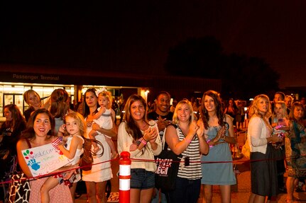 Family and friends of the 16th Airlift Squadron, 437th Airlift Wing, wait for their loved ones to return from deployment to at Joint Base Charleston - Air Base, S.C., July 2, 2012. While deployed, the 16th AS served under the 816th Expeditionary Airlift Squadron, supporting combat operations in the U.S. Central Command area of responsibility. (U.S. Air Force photo by Airman 1st Class George Goslin/Released)