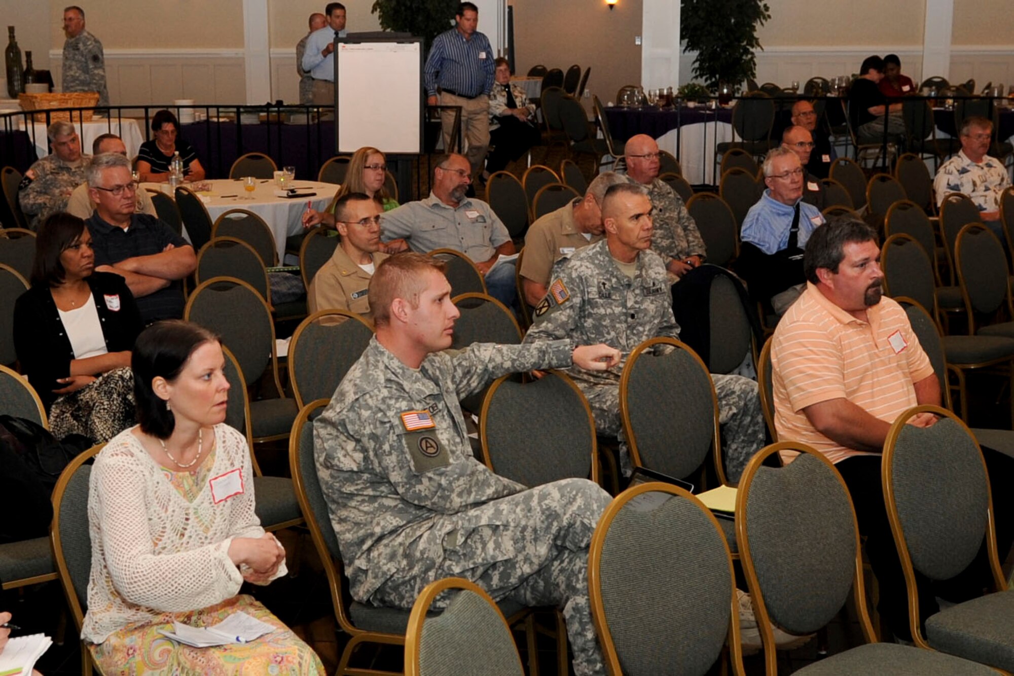 Attendees participate in a question and answer session at the Joint Base Langley-Eustis Unit Ministry Team's Spiritual Symposium at the Point Plaza Suites in Newport News, Va., June 19, 2012.During the symposium, attendees learned how to better help Service members and families dealing with combat stress, post-traumatic stress disorder, or upcoming or past deployments. (U.S. Air Force photo by Senior Airman Wesley Farnsworth)