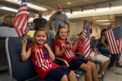 Kinsley and Karley Bordeaux, daughters of Master Sgt. Harold Bordeaux Jr., 16th Airlift Squadron, 437th Airlift Wing loadmaster, wait for their father to return from deployment at Joint Base Charleston - Air Base, S.C., July 2, 2012. While deployed, the 16th AS served under the 816th Expeditionary Airlift Squadron, supporting combat operations in the U.S. Central Command area of responsibility. (U.S. Air Force photo by Airman 1st Class George Goslin/Released)