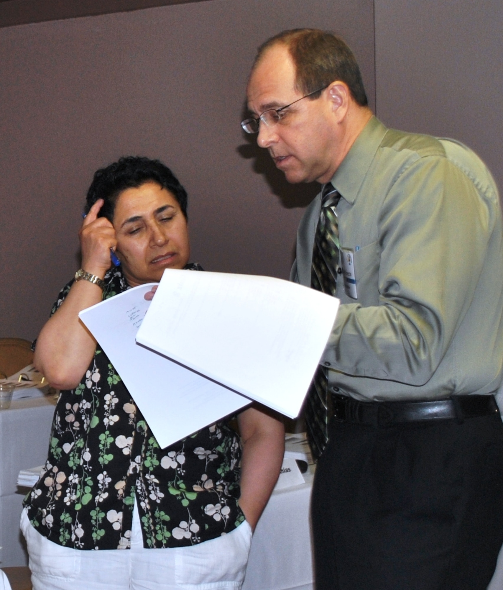 Mr. Bobby Roberts, Air Force Real Estate Subject Matter Expert, discusses course materials with one of many real property specialists from across the Air Force whom  completed the Advanced Realty Course in San Antonio, TX on June 19-22, 2012.  (USAF Photo/Armando Perez)