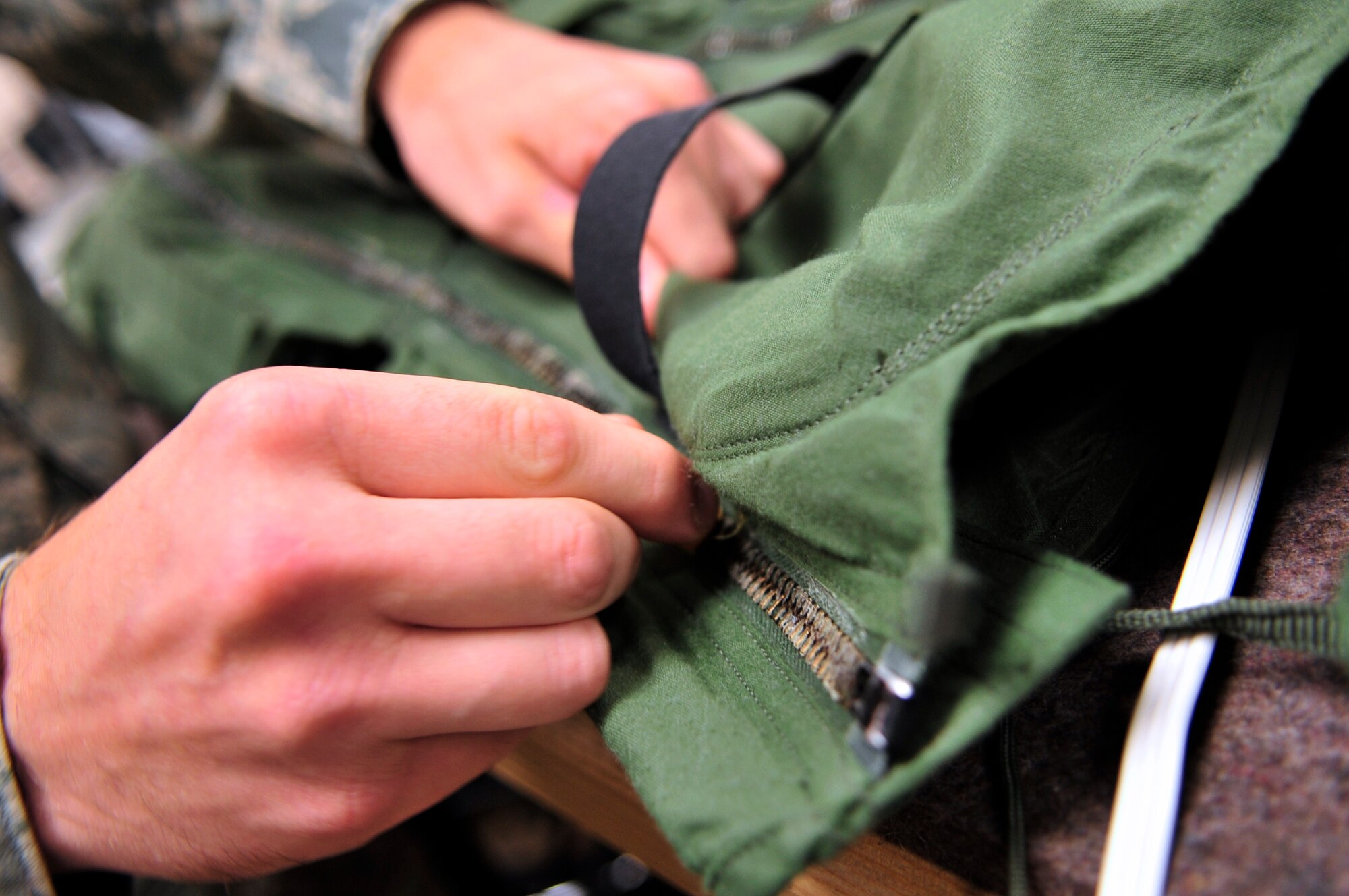 U.S. Air Force Senior Airman Daniel Burnette, 79th Fighter Squadron aircrew flight equipment specialist, prepares an anti gravity flight suit at Shaw Air Force Base, S.C., June 29, 2012.  Aircrew flight equipment personnel are responsible for ensuring the safety of the fighter pilots and integrity of their equipment.(U.S. Air Force photo by Airman Nicole Sikorski/Released) 