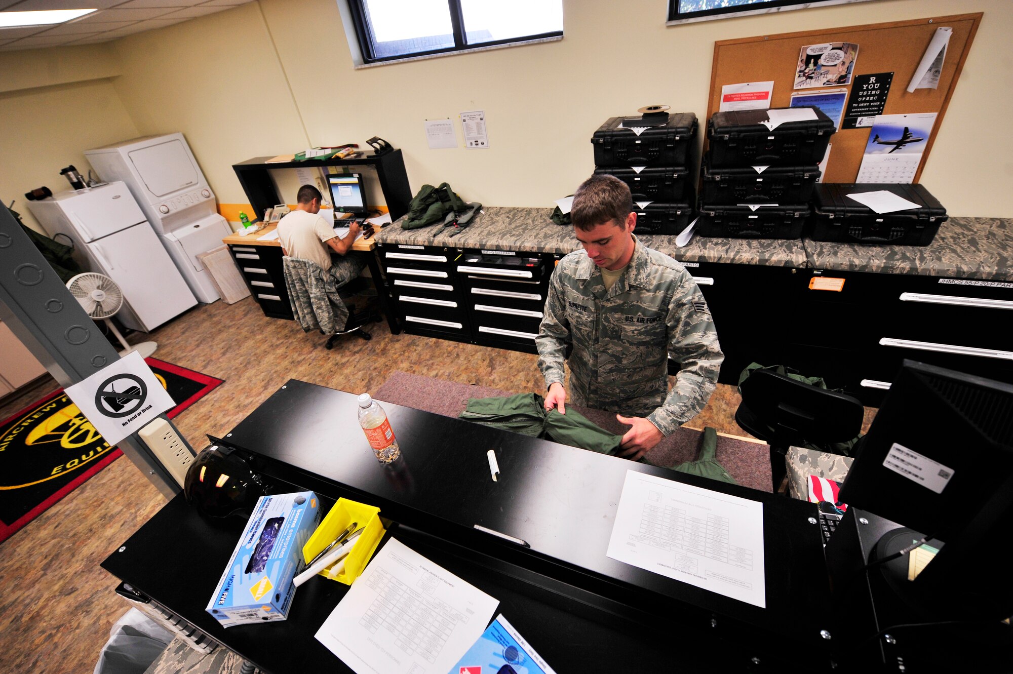 U.S. Air Force Airmen from the 79th Fighter Squadron's aircrew flight equipment work at the 79th Fighter Squadron Shaw Air Force Base, S.C., June 29, 2012.  Aircrew flight equipment personnel are responsible for ensuring the safety of the fighter pilots and integrity of their equipment.(U.S. Air Force photo by Airman Nicole Sikorski/Released) 
