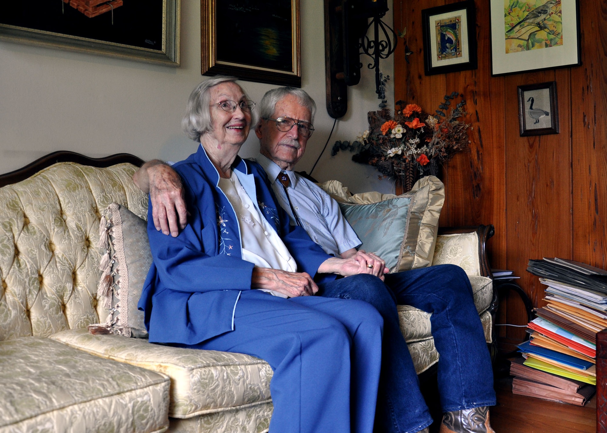 James Bollich and his wife Celia sit amongst books and artwork in their Lafayette, La. home June 13. James Bollich survived the Bataan Death March and spent three and a half years as a Prisoner of War during World War II. He and his wife met while in graduate school the University of New Mexico. (U.S. Air Force photo by Kate Blais)