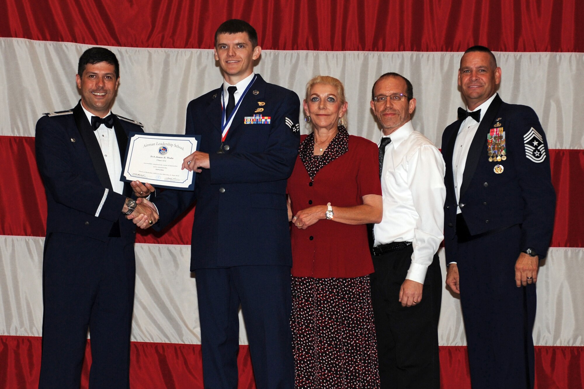 Col. Andrew Gebara, commander of the 2nd Bomb Wing and Senior Airman Jason Woda, 307th Logistics Readiness Squadron, pose for a photo during the graduation ceremonies for Class 12-4 of the Airman Leadership School in Hoban Hall at Barksdale Air Force Base, La., June 28, 2012. The Reserve units at Barksdale receive at least one billet for each month long class. (U.S. Air Force photo by Airman 1st Class Benjamin Gonsier) 