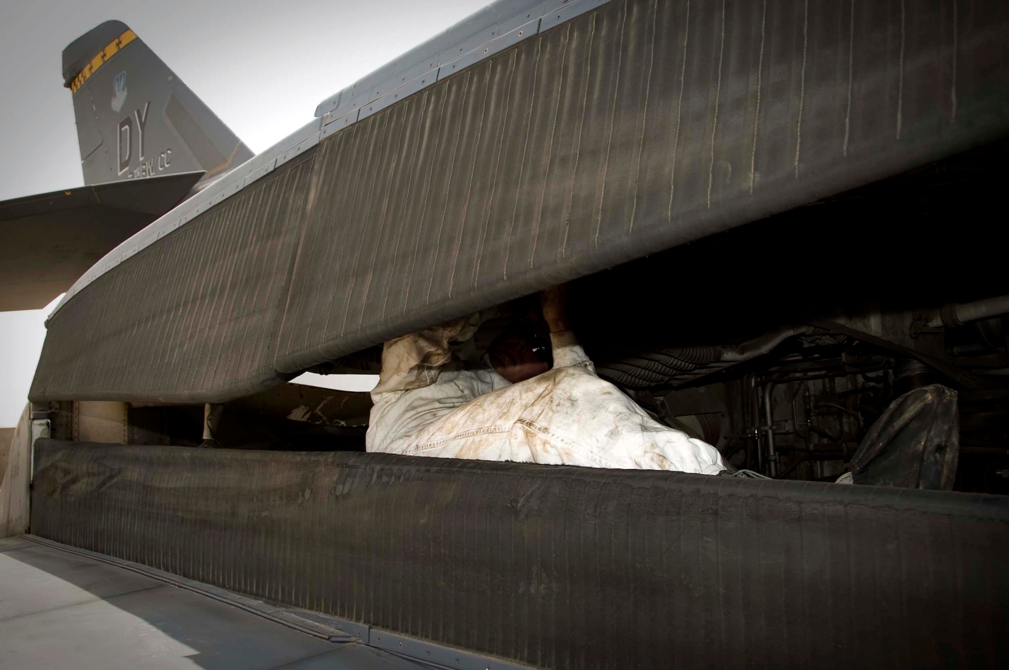 U.S. Air Force Senior Airman Joshua Jackson, 379th Expeditionary Aircraft Maintenance Squadron instrument flight and control systems technician, adjusts an over-wing fairing on a B-1 Lancer during a routine inspection in Southwest Asia, July 2, 2012. Jackson is deployed from Dyess Air Force Base, Texas and is a native of Barbourville, Ky. (U.S. Air Force photo/Staff Sgt. Sheila deVera)