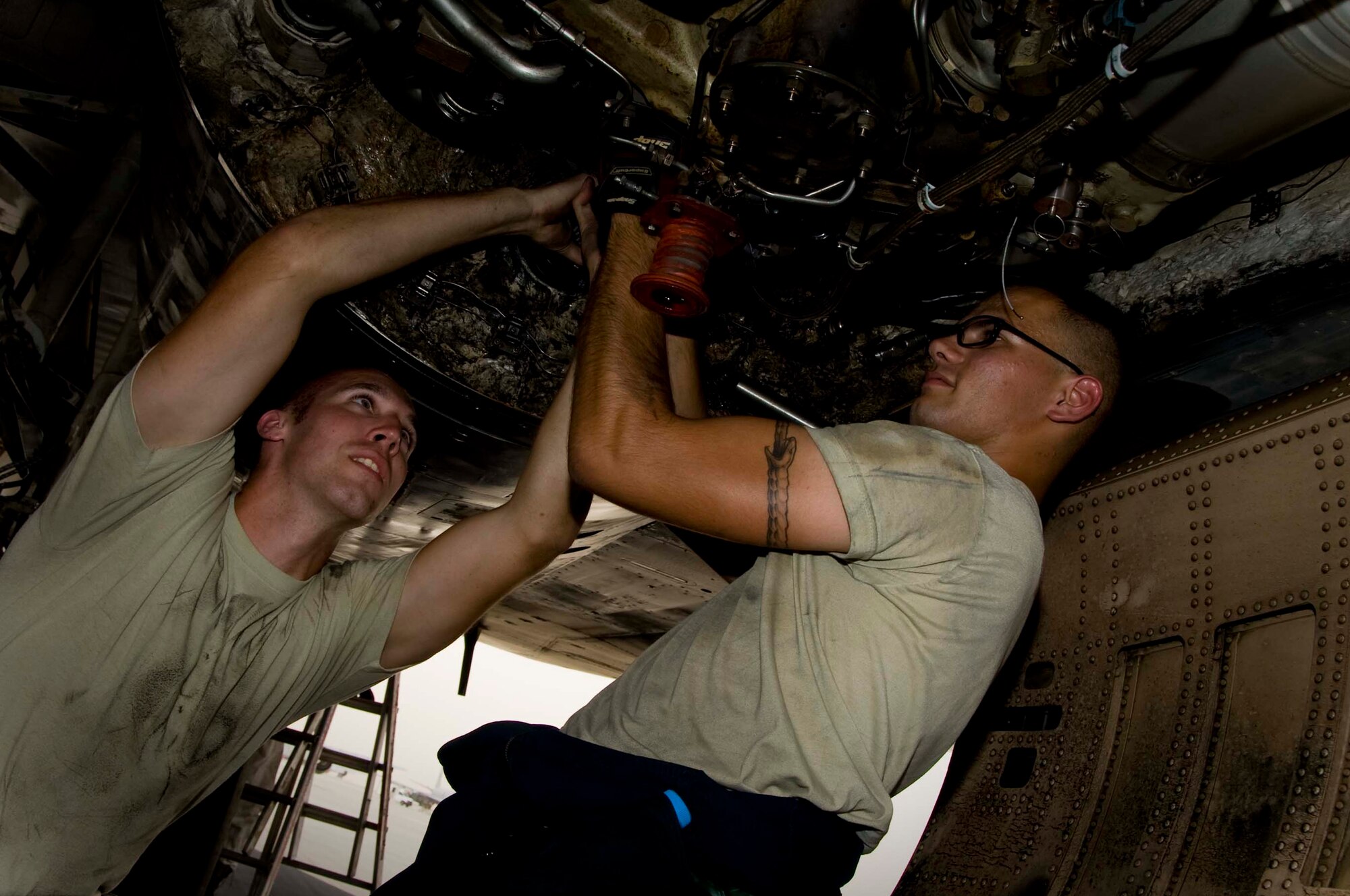 U.S. Air Force Airman 1st Angel Flores (right), propulsion system technician, and Senior Airman Brandon Linamen, electric warfare journeyman, perform a post-install inspection on a B-1 Lancer in Southwest Asia, July 2, 2012. Both Airmen are assigned to the 379th Expeditionary Aircraft Maintenance Squadron and are deployed from Dyess Air Force Base, Texas. Flores is a native of Parker, Colo., and Linamen is from  Boone, N.C. (U.S. Air Force photo/Staff Sgt. Sheila deVera)
