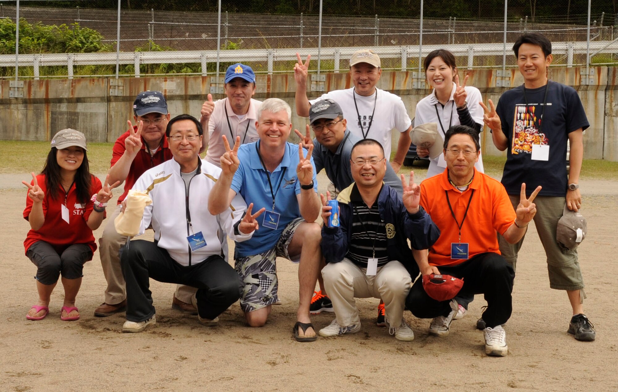 Team Falcon poses for a picture after winning first place during Sports Day at Misawa Air Base, Japan, June 30, 2012. Team Falcon finished four points ahead of those following with a score of 28 after competing in four different games. (U.S. Air Force photo by Airman 1st Class Kaleb Snay/Released)