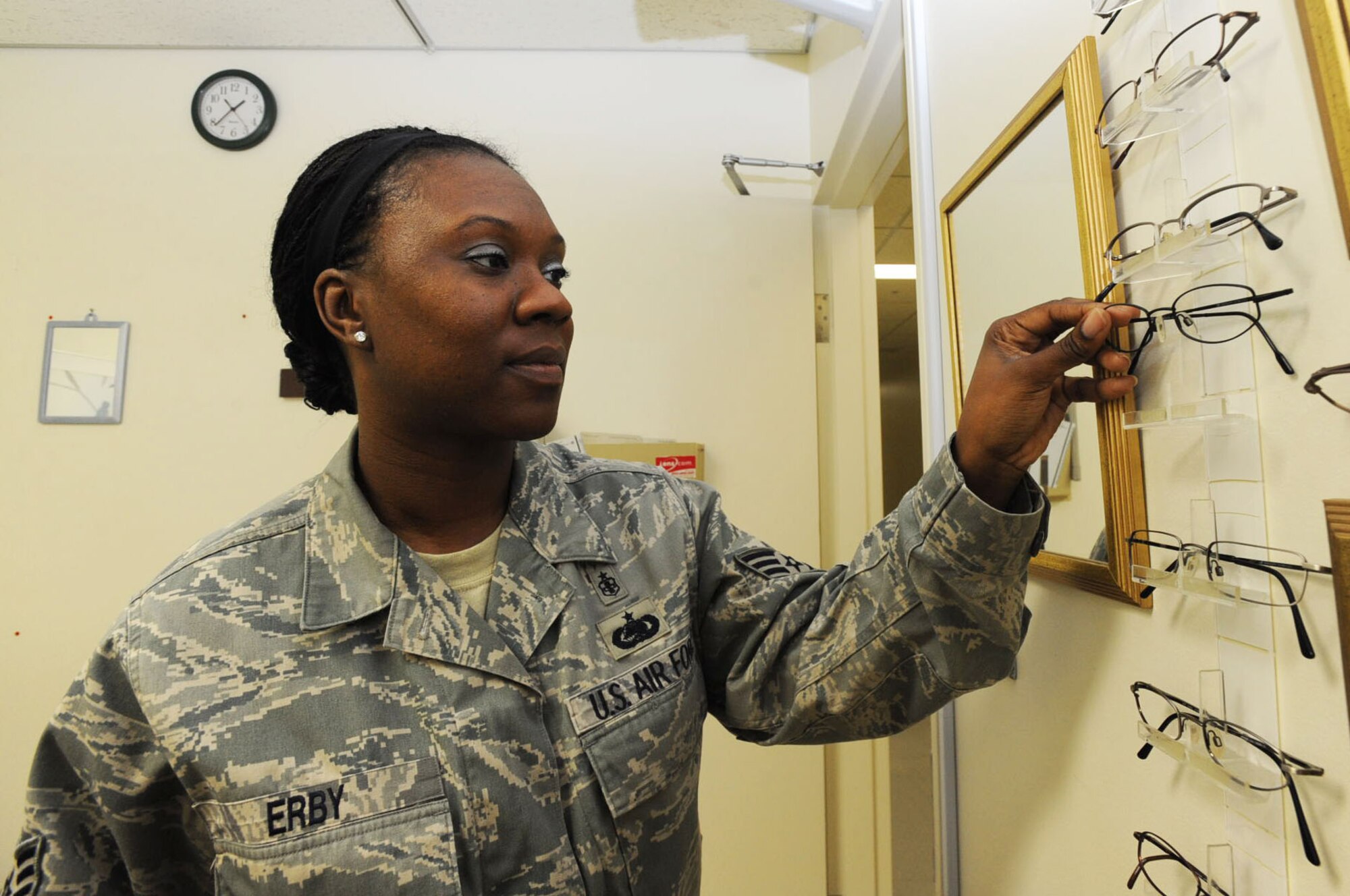 U.S. Air Force Tech. Sgt. Shavahn Erby, 35th Aerospace Medicine Squadron optometry flight chief, places frames on a rack after helping a customer find new frames at Misawa Air Base, Japan, July 3, 2012. The 35th Aerospace Medicine Squadron’s mission is to support the 35th Fighter Wing through superior aero medical, occupational, environmental and preventative medicine programs. (U.S. Air Force photo by Airman 1st Class Kenna Jackson/Released)