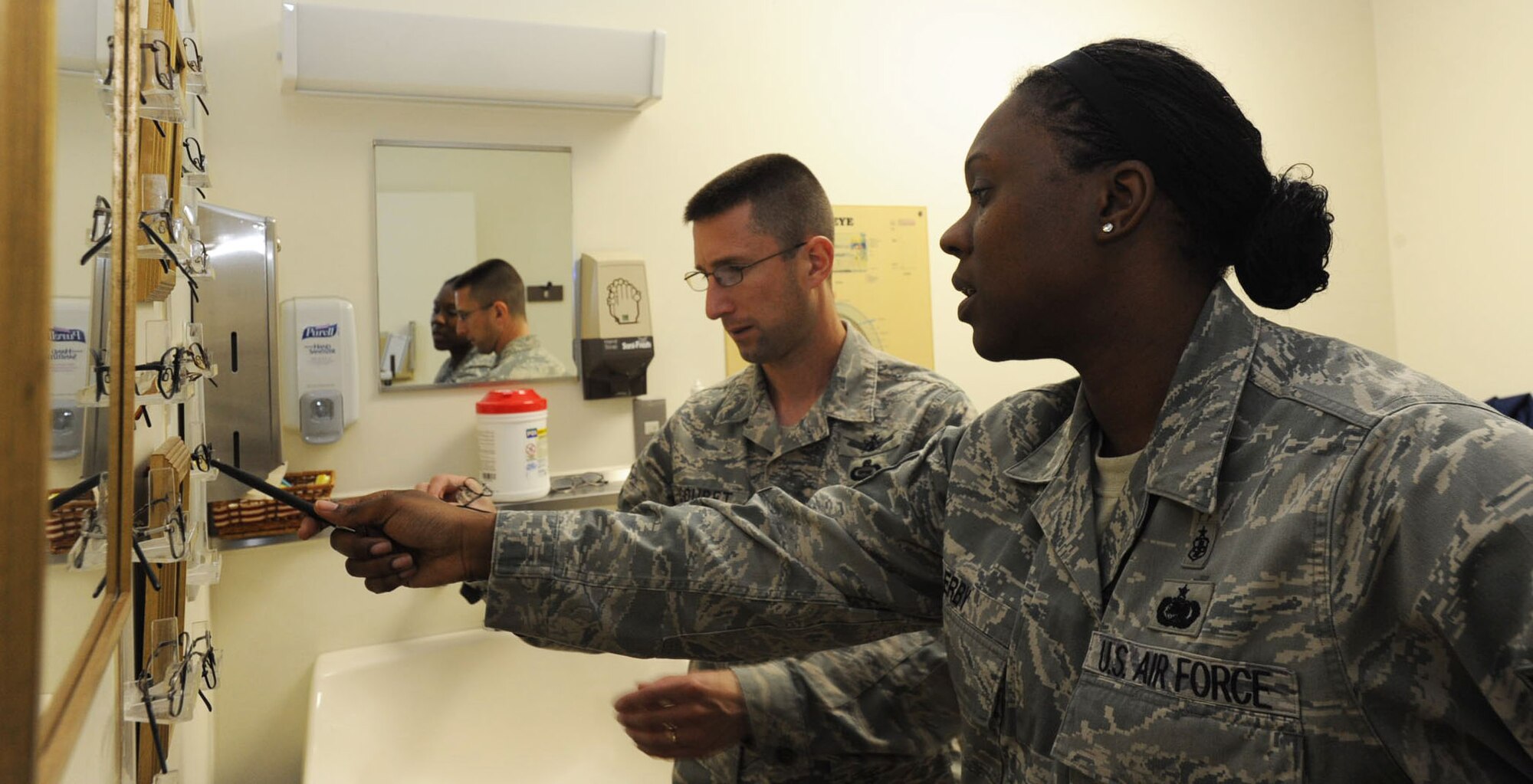 U.S. Air Force Tech. Sgt. Shavahn Erby, right, 35th Aerospace Medicine Squadron optometry flight chief, helps Chief Master Sgt. William Couret, 301st Intelligence Squadron superintendent, pick out new frames at Misawa Air Base, Japan, July 3, 2012. To make an appointment, call the optometry contact number at 226-6111. (U.S. Air Force photo by Airman 1st Class Kenna Jackson/Released)