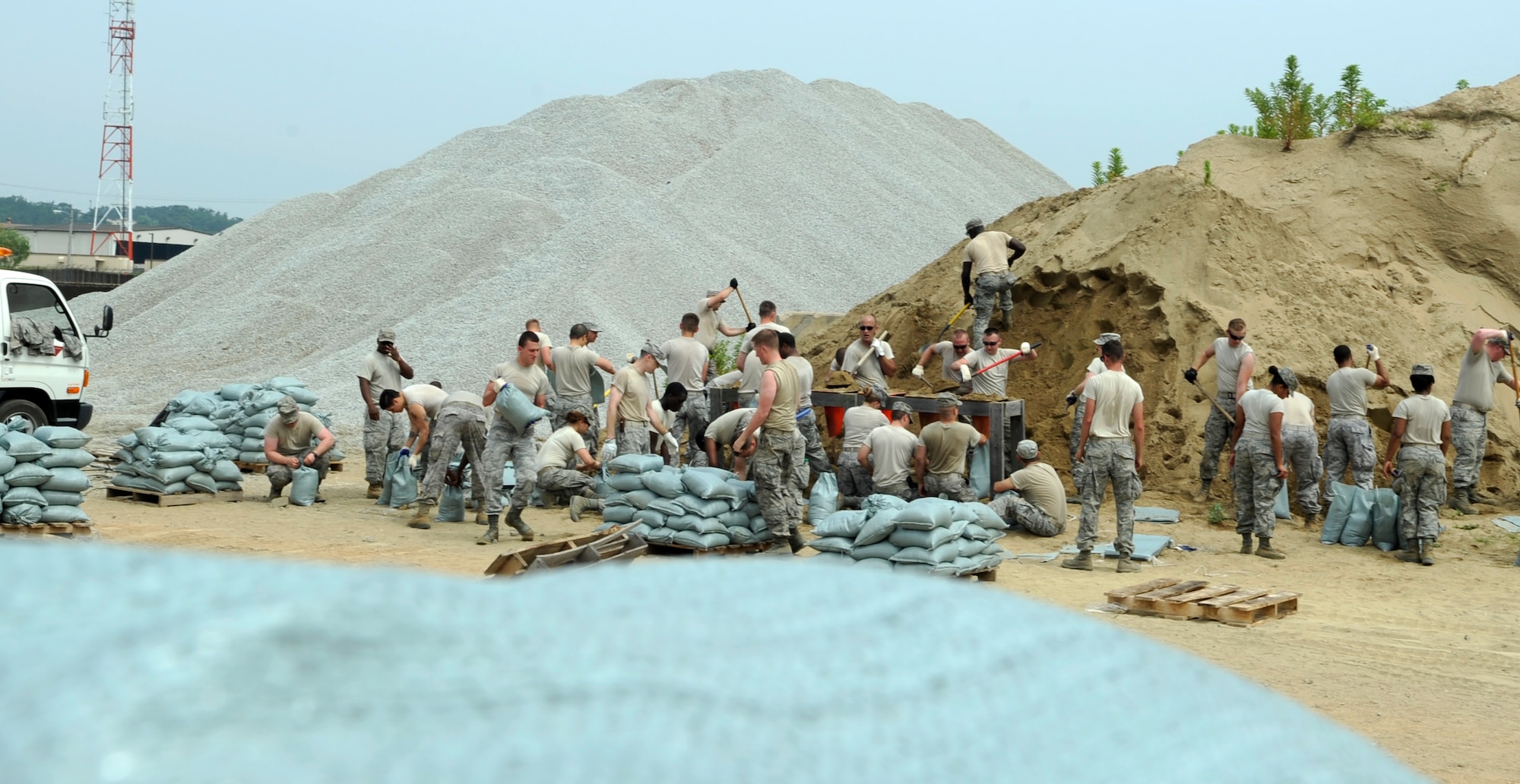 Airmen from the 8th Fighter Wing fill sandbags to prepare the base for monsoon season June 29, 2012, at Kunsan Air Base, Republic of Korea. During the next few weeks, the area will receive about 50 percent of its annual rainfall. (U.S. Air Force photo/Senior Airman Brigitte N. Brantley)