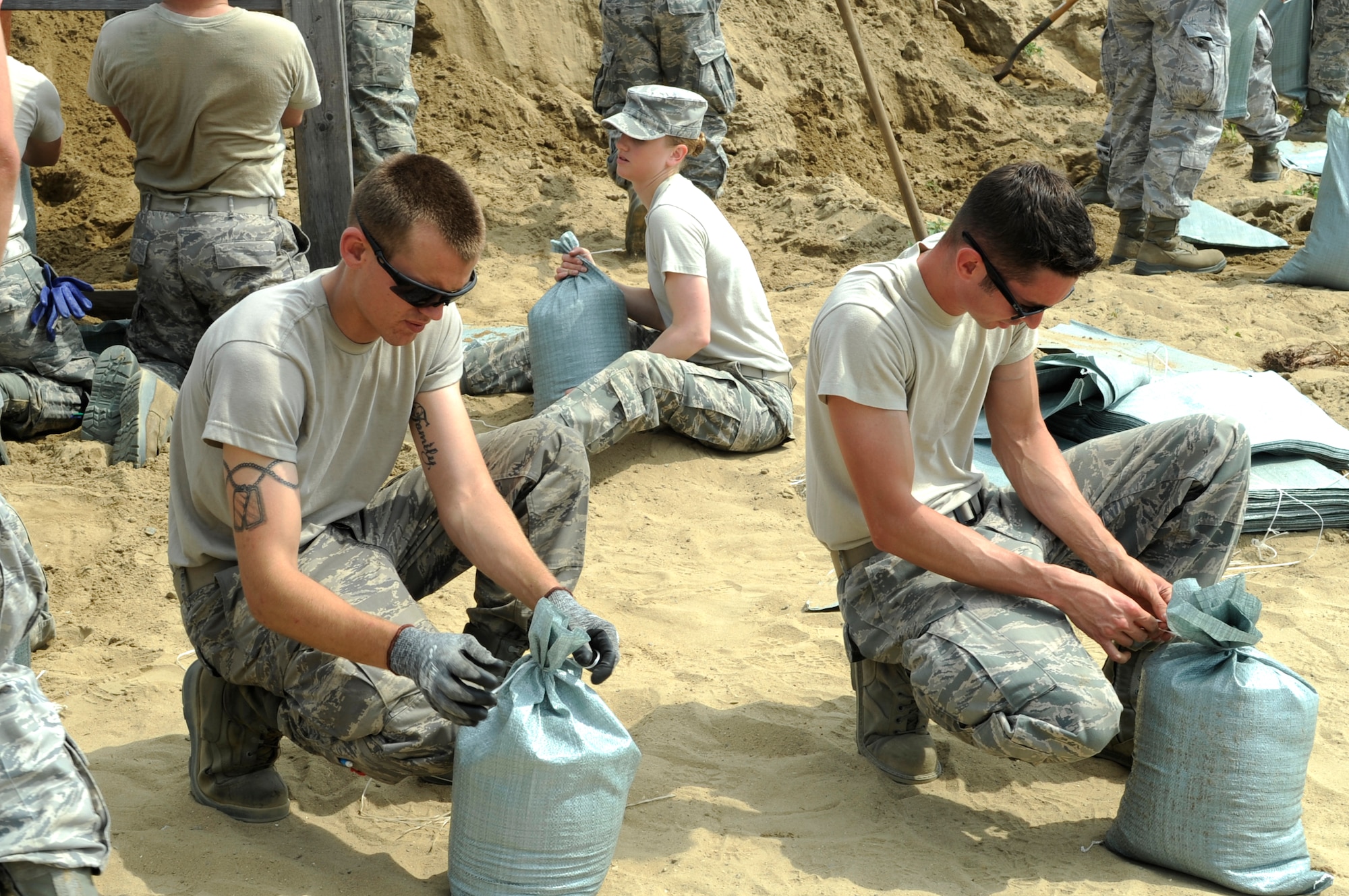 Members from around the Wolf Pack pitched in June 29, 2012, at Kunsan Air Base, Republic of Korea, to pack 5,000 sandbags. The sandbags are strategically placed around base and will be used to protect mission-essential assets during heavy rains. (U.S. Air Force photo/Senior Airman Brigitte N. Brantley)