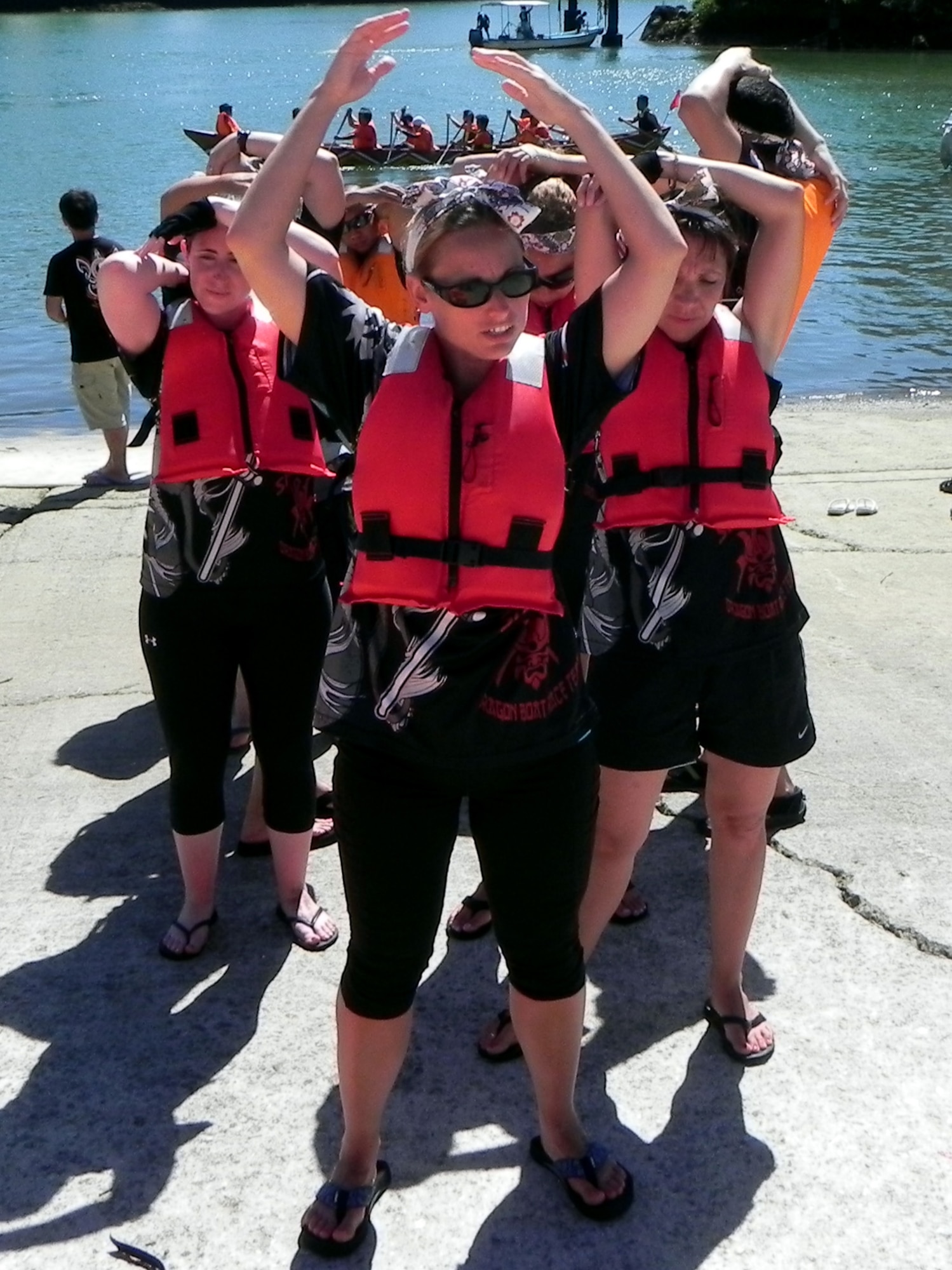 The Kadena Shogun dragon boat coed team warms up before they get in their boat for their heat at Kadena Town Fishery Port, June 24, 2012. Kadena Air Base, Japan's, Shogun racers participated in the 25th Kadena Town Boat Race, raced against two local teams and finished the first place in the heat. The race distance is 500 meters in round trip. A total of 60 teams competed in the races and nine best teams by time raced in semi finals. (U.S. Air Force photo/Hideaki Sakihama)