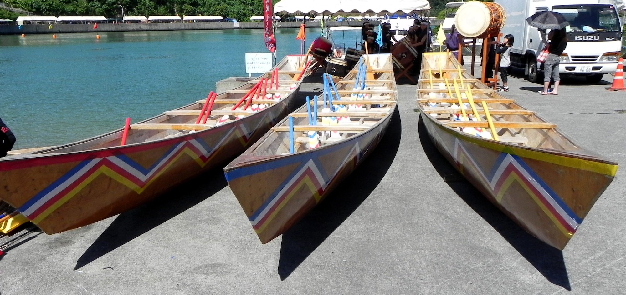 Three traditional fishermen's ships are laid out to be used for the dragon boat races. The ships are about five meters long at the Kadena Town Fishery Port, June 24, 2012. Less than 12 rowers, one coxswain and one navigator are on board during the race. Each local Okinawan community with a fishing port will typically host its own boat race in June. (U.S. Air Force photo/Hideaki Sakihama)