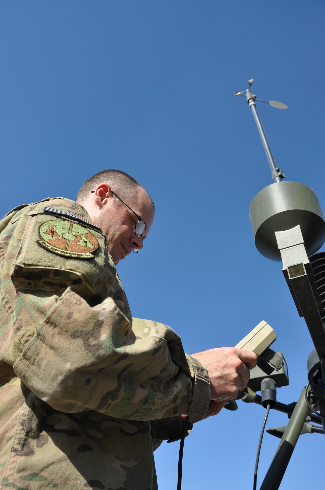 TSgt. Neel Rodgers, a Battlefield Weather Forecaster with 19th Expeditionary Weather Squadron, checks readings on the Tactical Meteorological Observing System (TMQ-53) June 30 at Bagram Field, Afghanistan. Weather forecasters use the system to get current weather conditions such as winds, temperature, humidity, range of visibility, cloud ceiling, and to detect lightning. Rodgers was recently named 455th Air Expeditionary Wing "Warrior of the Week."  According to Rodgers' peers, his knowledge and accurate anticipation of area weather patterns were instrumental in the successful completion of combat missions leading to interventions against 55 insurgents and the destruction of 82 Improvised Explosive Devices. (U.S. Air Force photo/TSgt Shawn David McCowan)