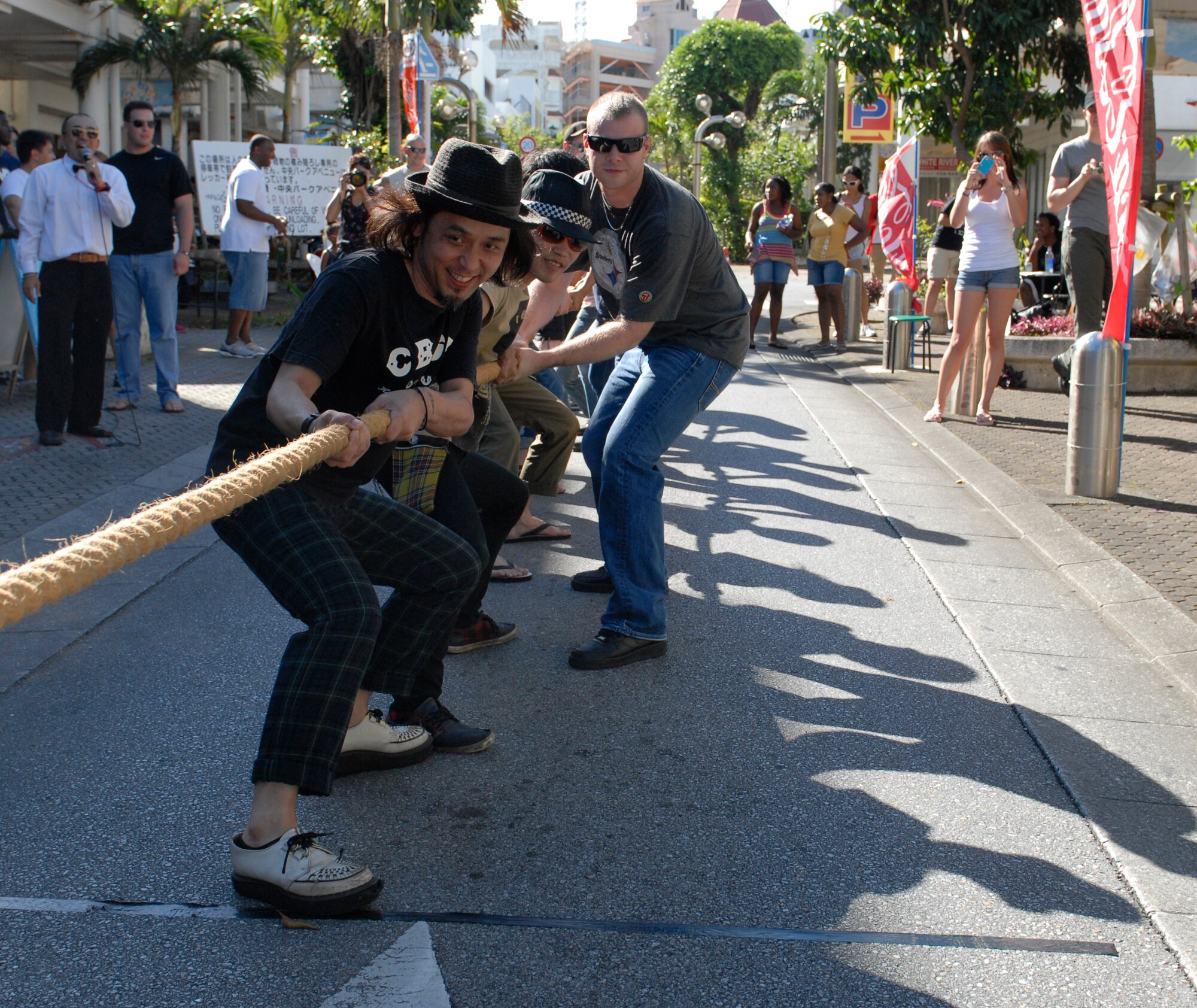Airmen team up with Okinawan community members for a tug-of-war competition at an event called Kanaderu Park at Chuo Park Avenue, Japan, June 30, 2012. The Kadena Air Force Sergeants Association and Airmen Committed to Excellence put together a team to participate in the contest to foster positive relations with the local community. (U.S. Air Force photo/Airman 1st Class Malia Jenkins)